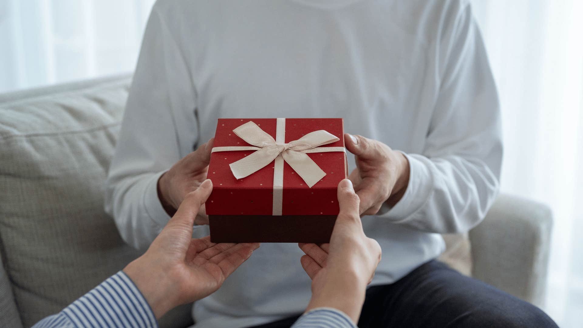 woman giving man gift