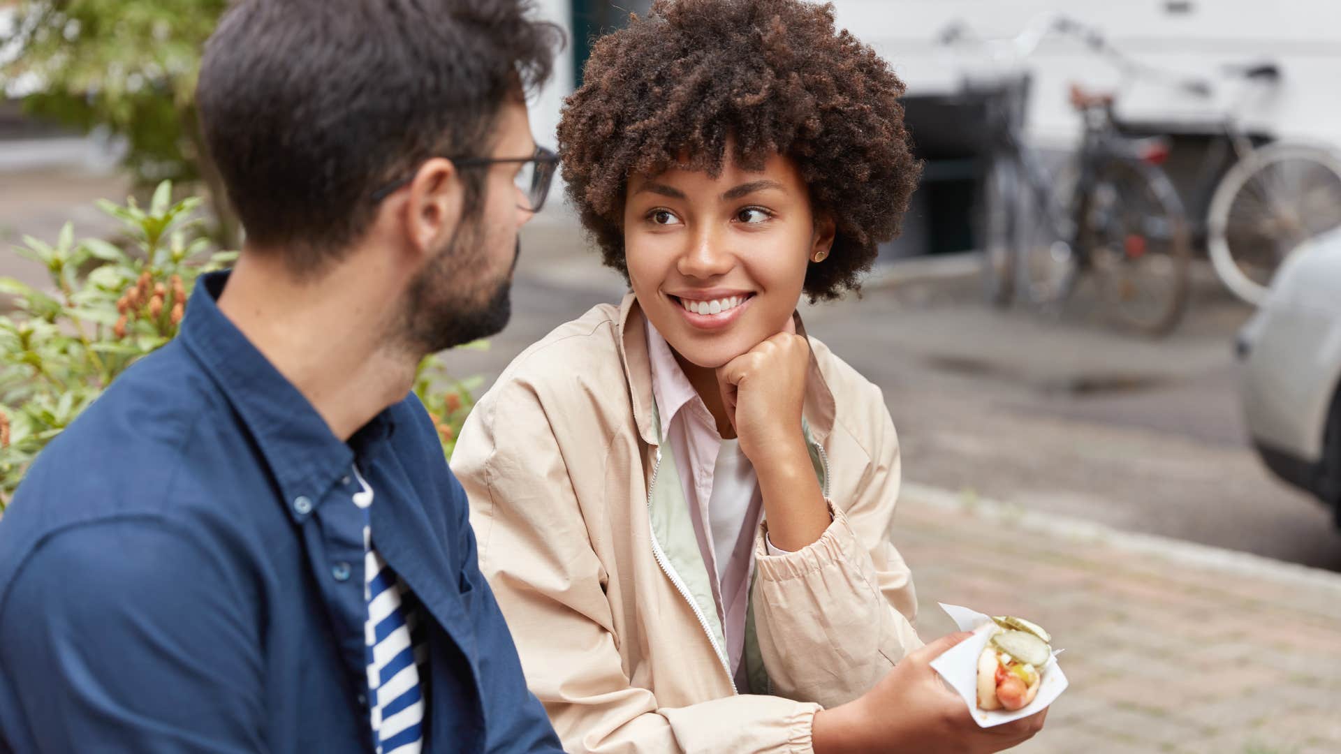 woman talking to man outside