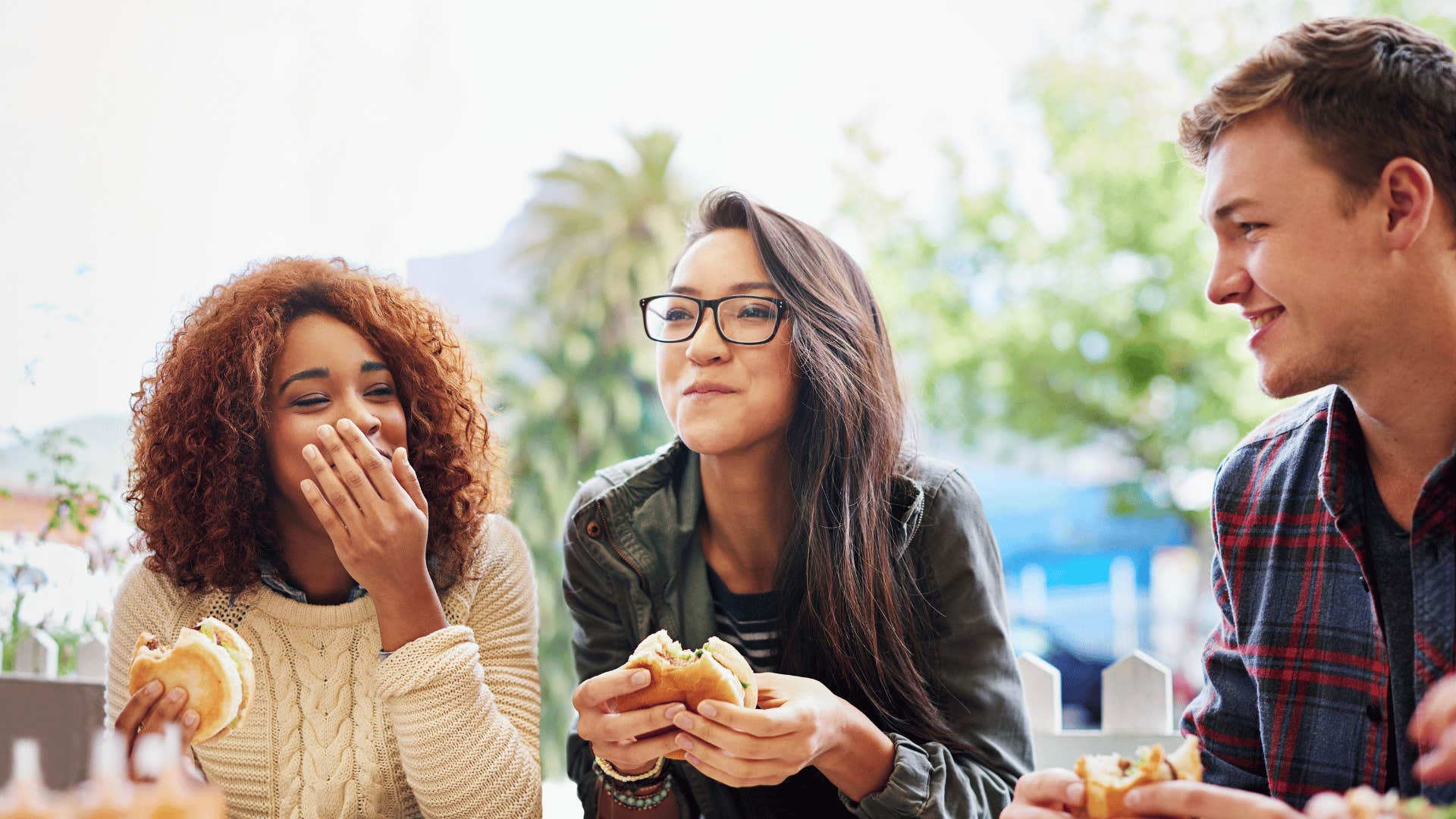 Two women laugh at man who think impressing them matters