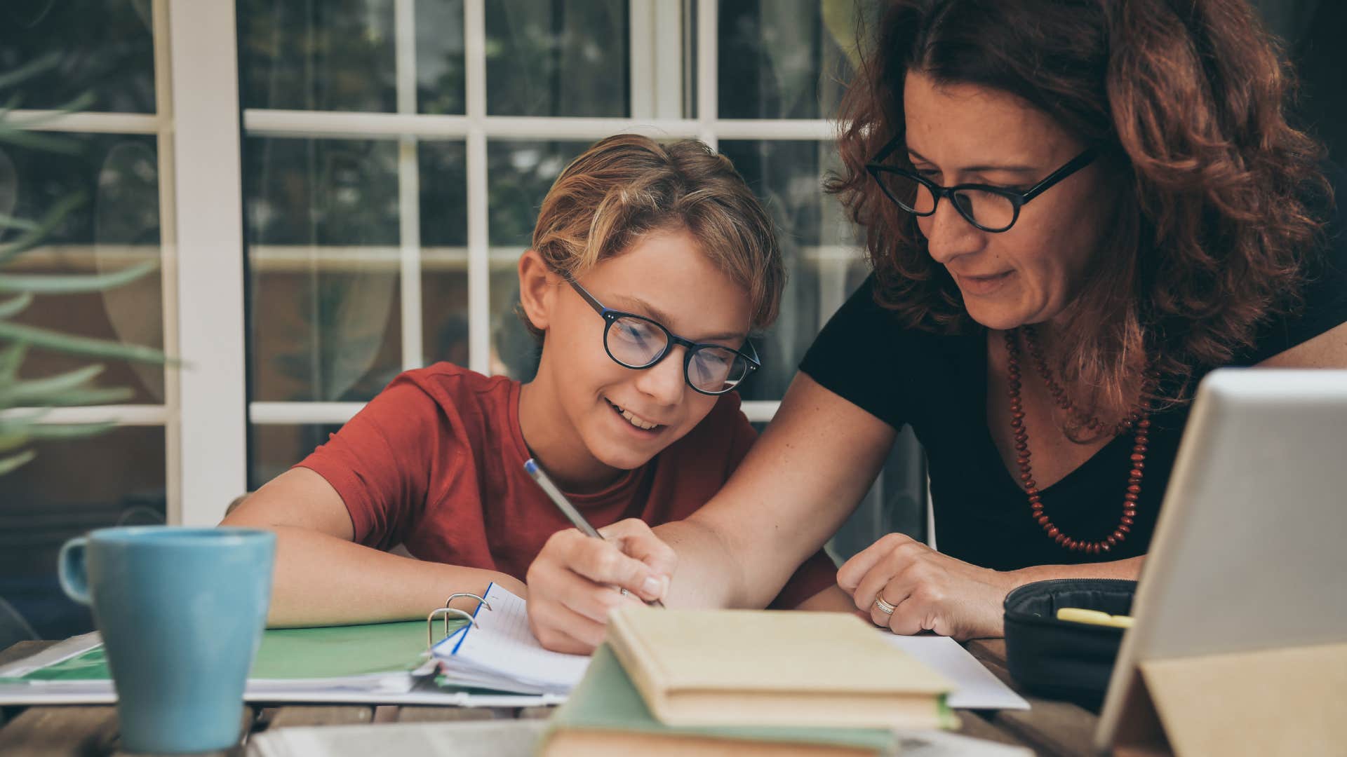 middle-class mother helping son with his education