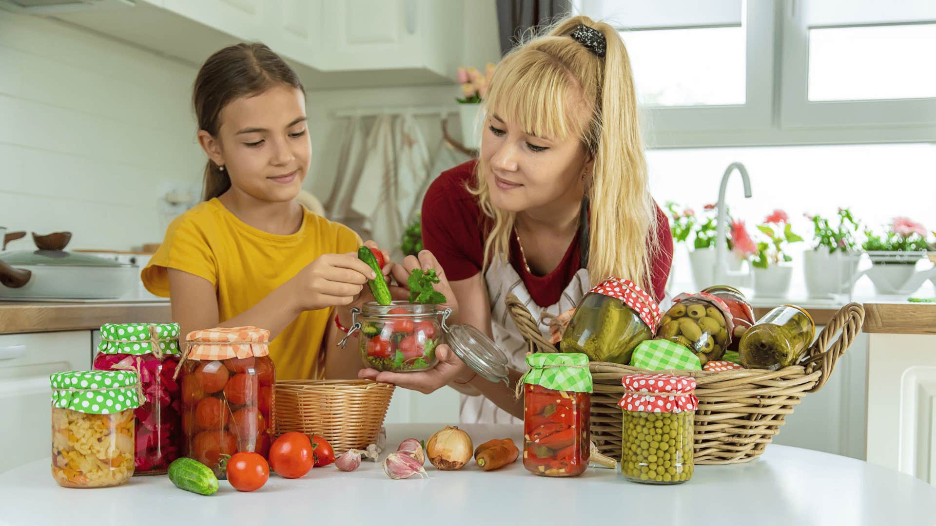mother and daughter making preserves
