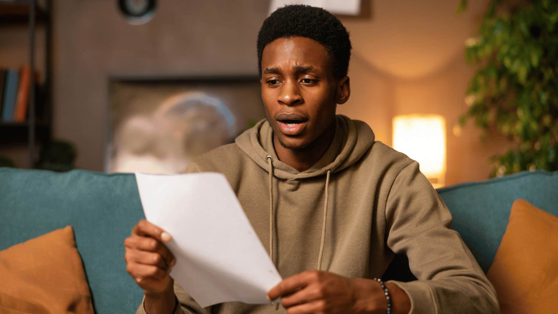 millennial man looking at student loan repayment bill