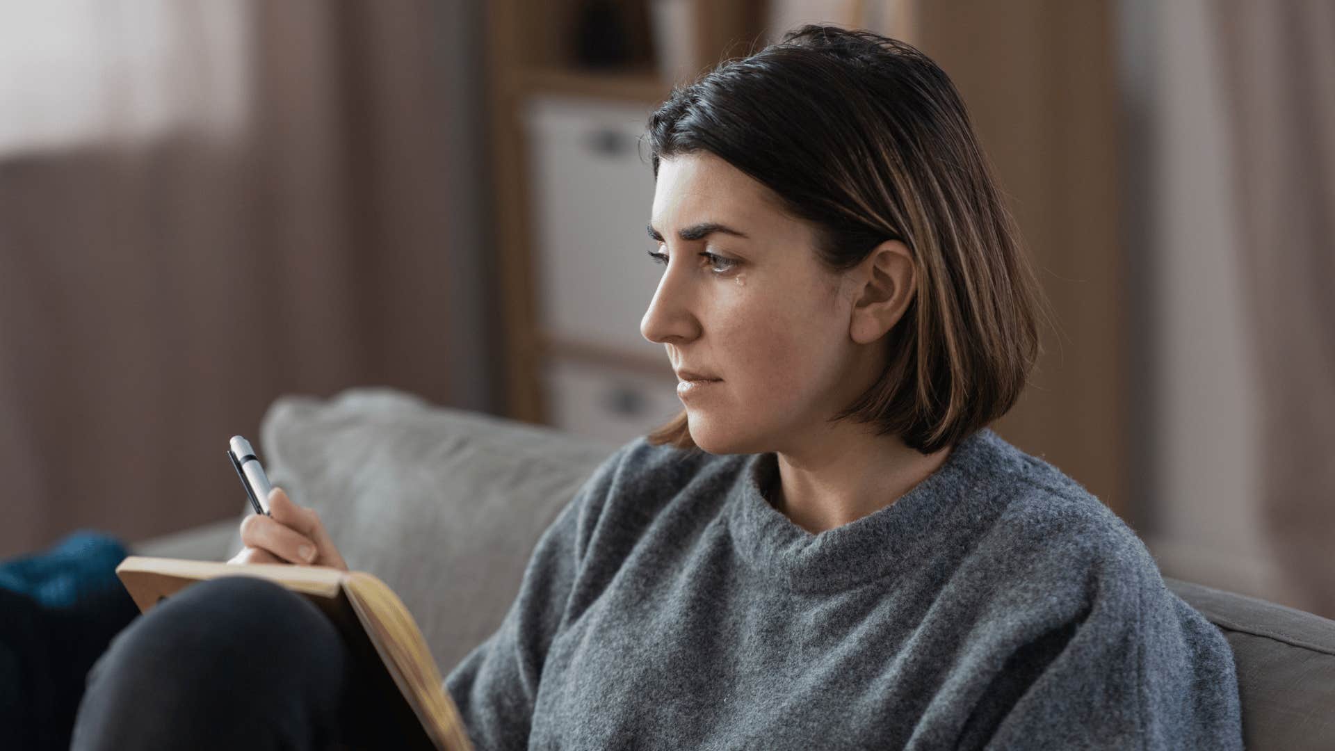 woman crying writing out a plan for her life