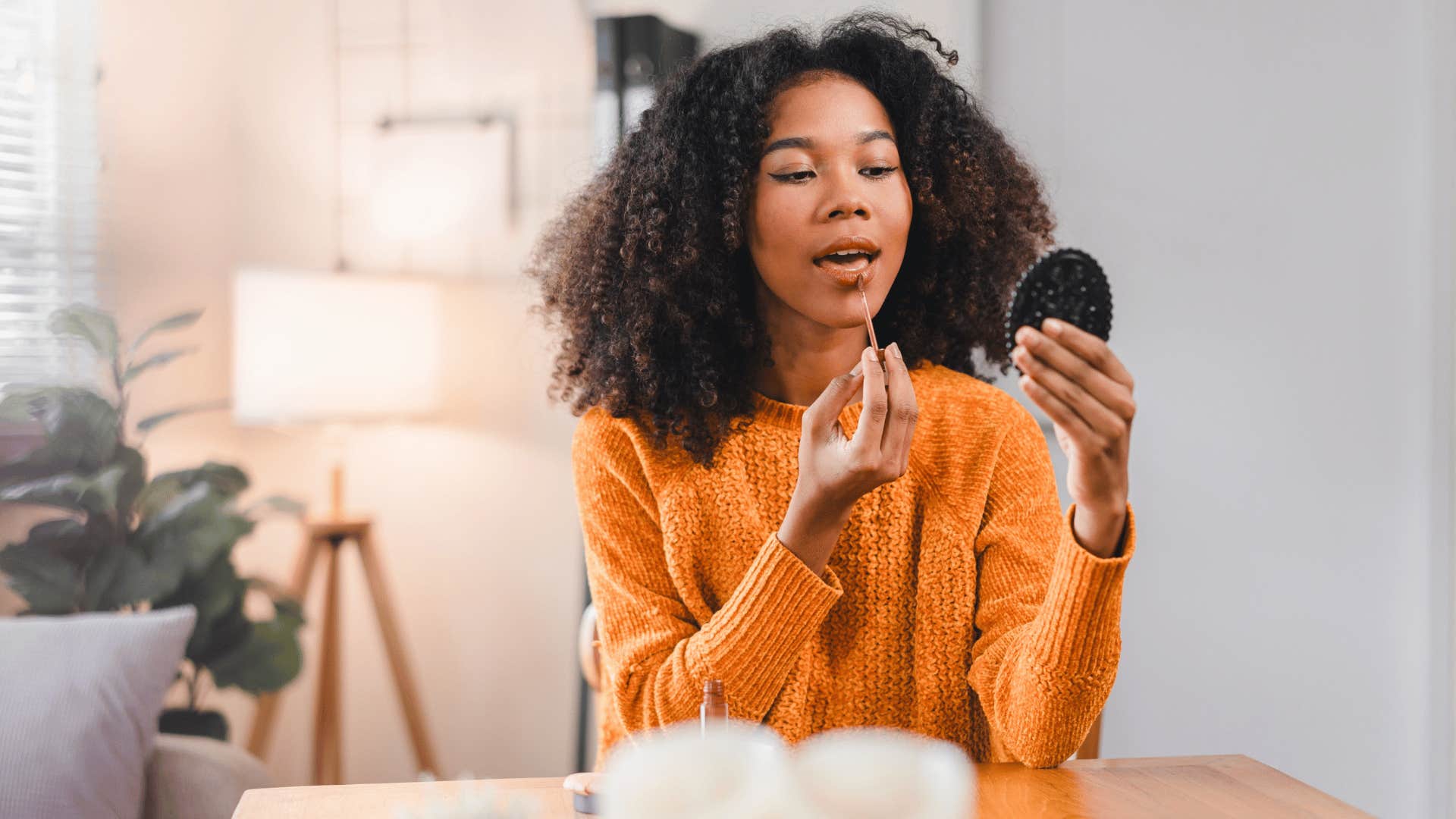 millennial putting on makeup before work