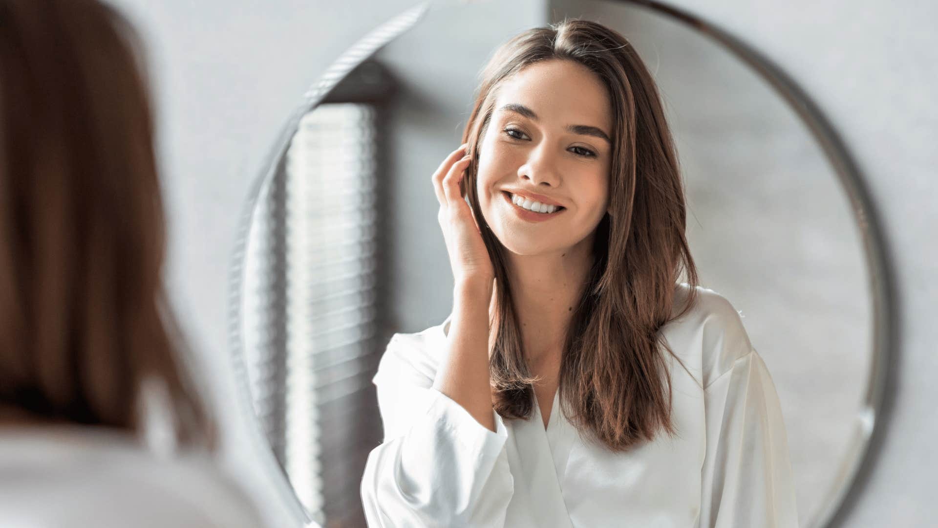 millennial woman looking in mirror overcoming flaws