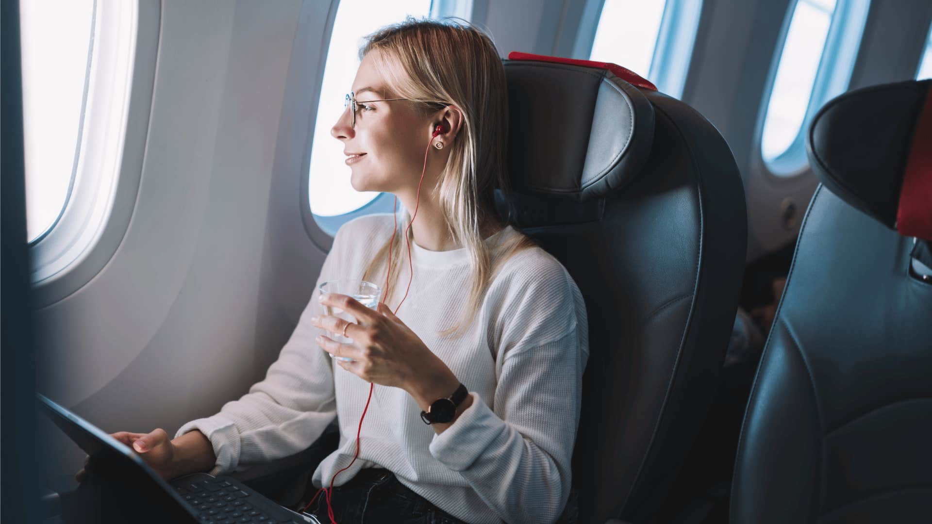 millennial woman traveling alone on plane