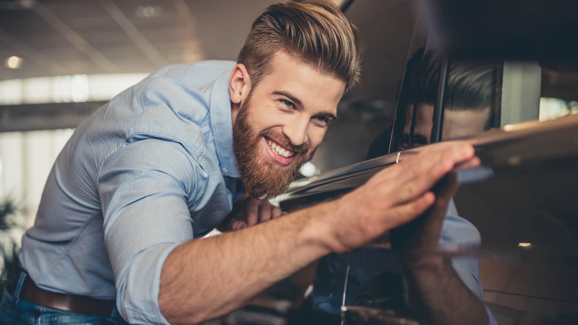 Man admiring a classic car in his garage