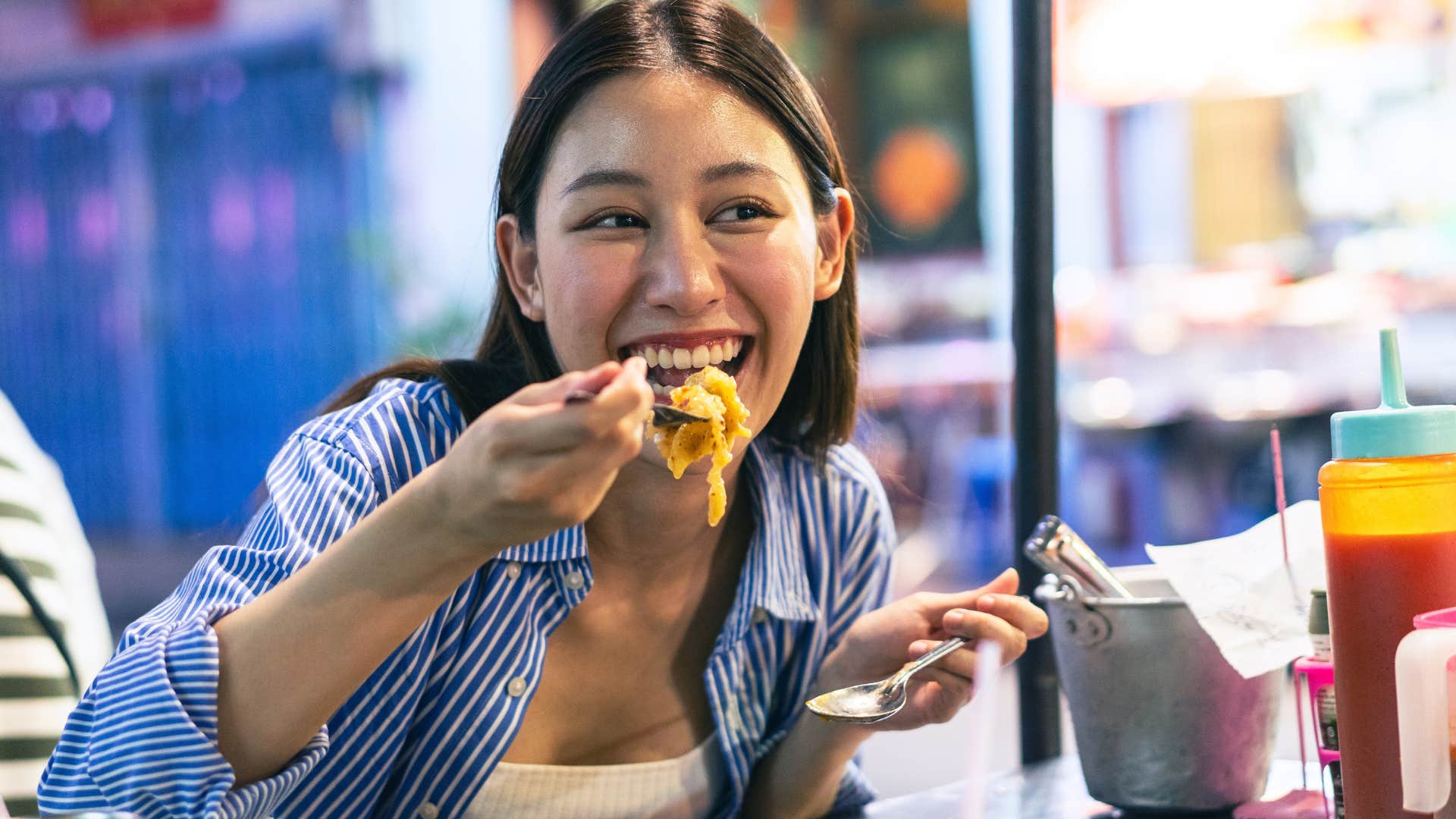 Millennial woman eating in a restaurant