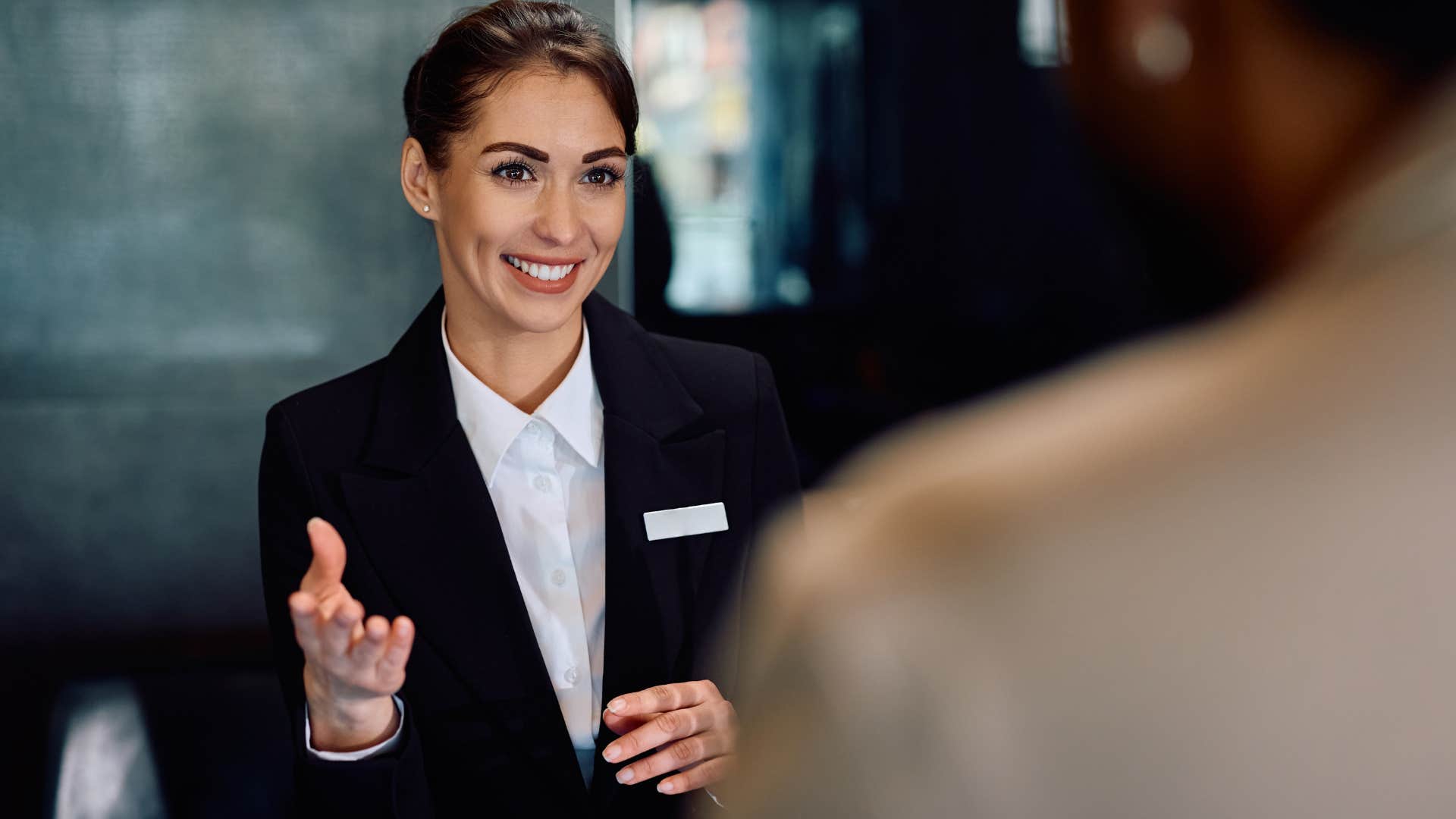 Hotel receptionist smiling at a man