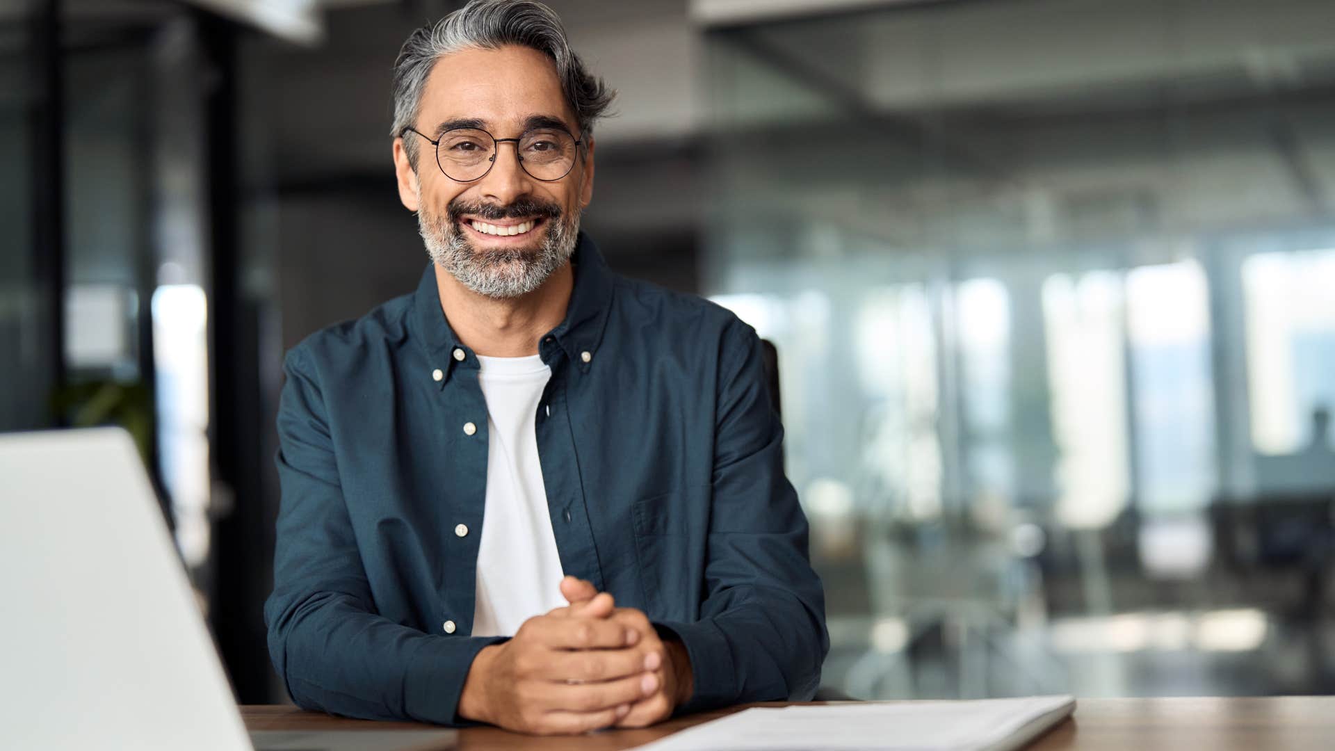 Professional man smiling while sitting in an office