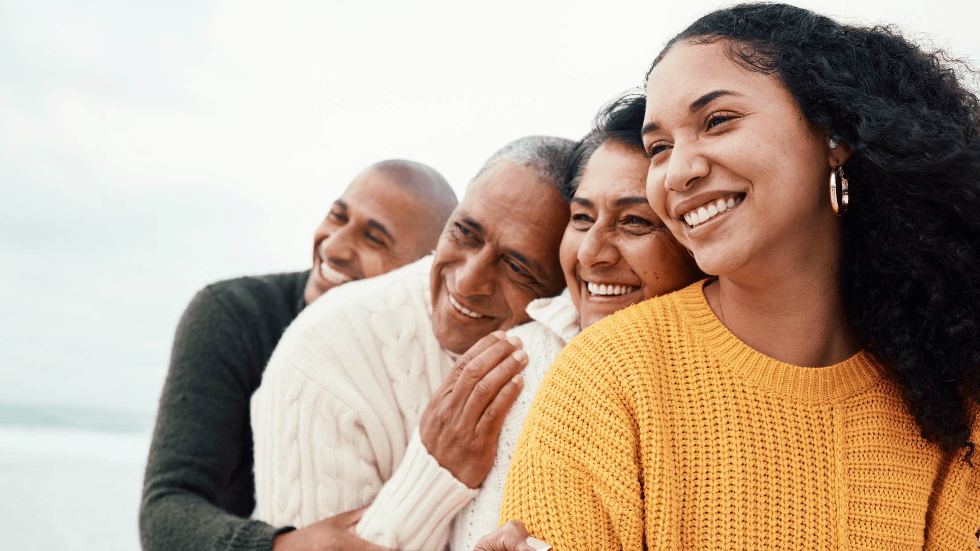 older parents smile with their adult children taught them that hard work always equals success