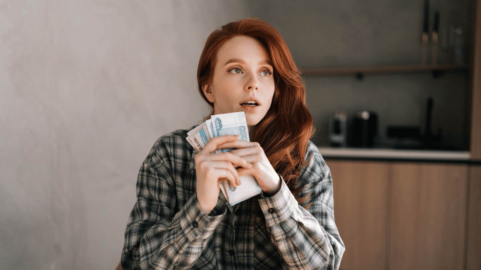 young woman with a wad of cash to spend