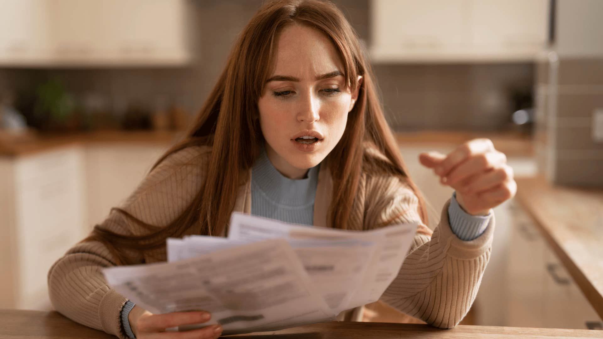shocked Gen Z woman looking at her bills