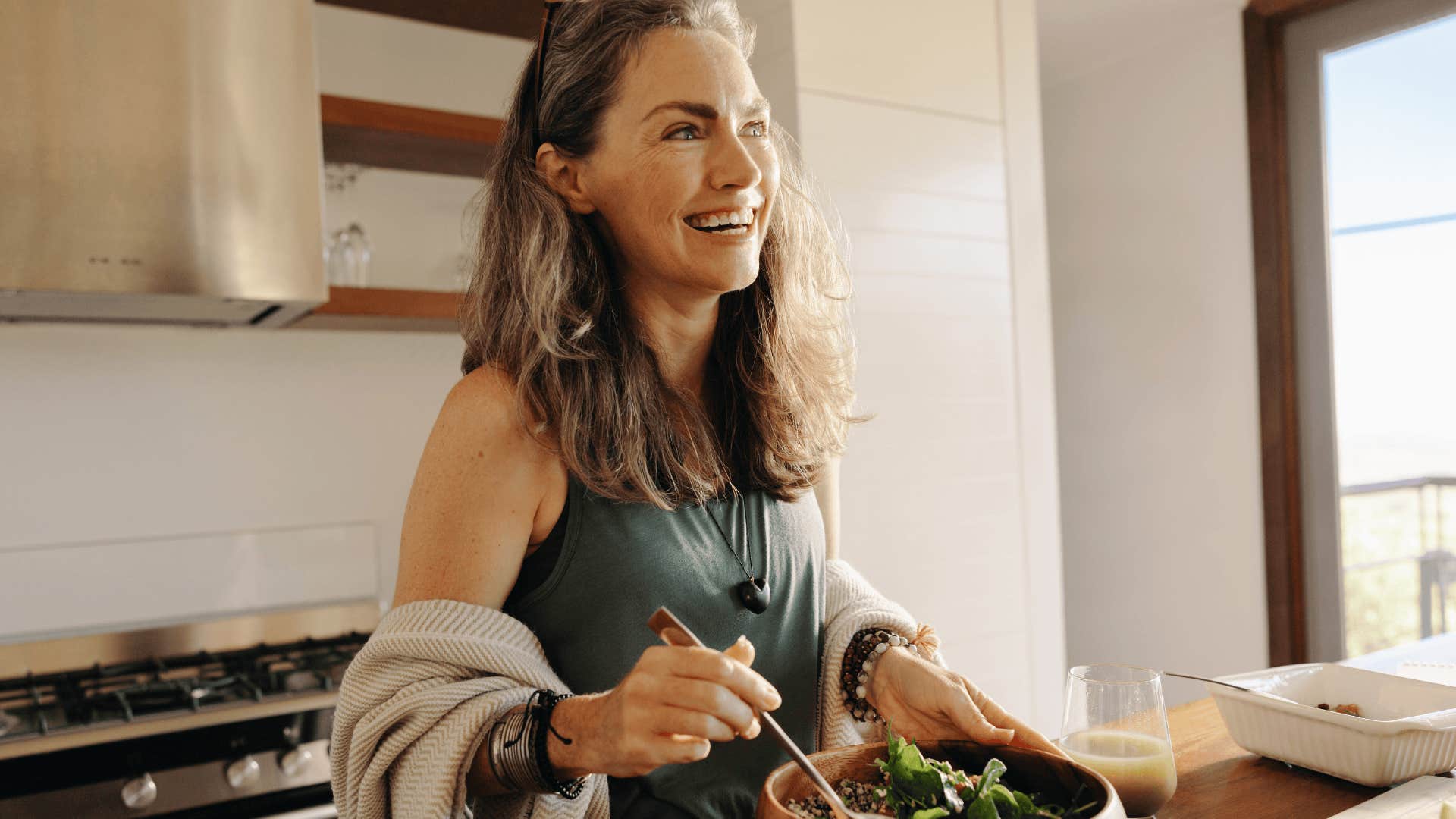 happy woman eating in the kitchen
