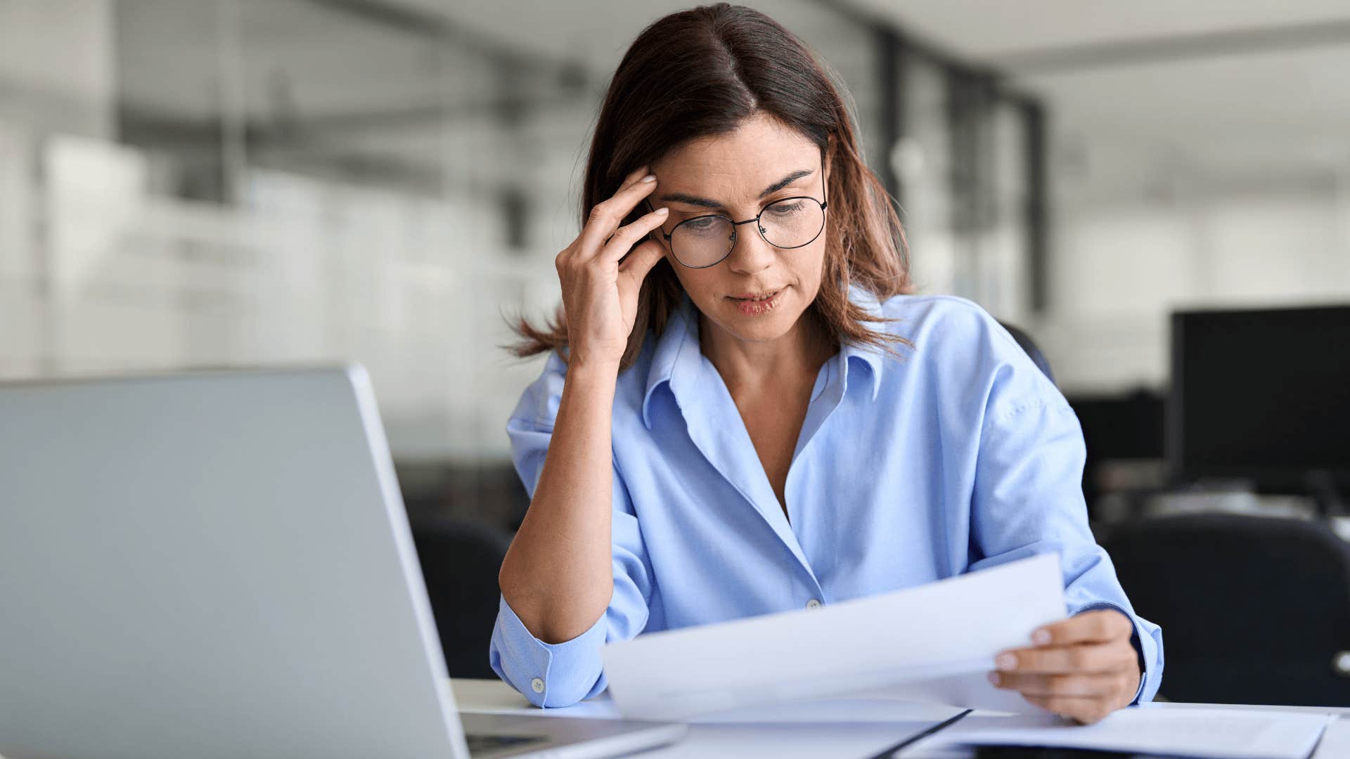 stressed woman working at her desk