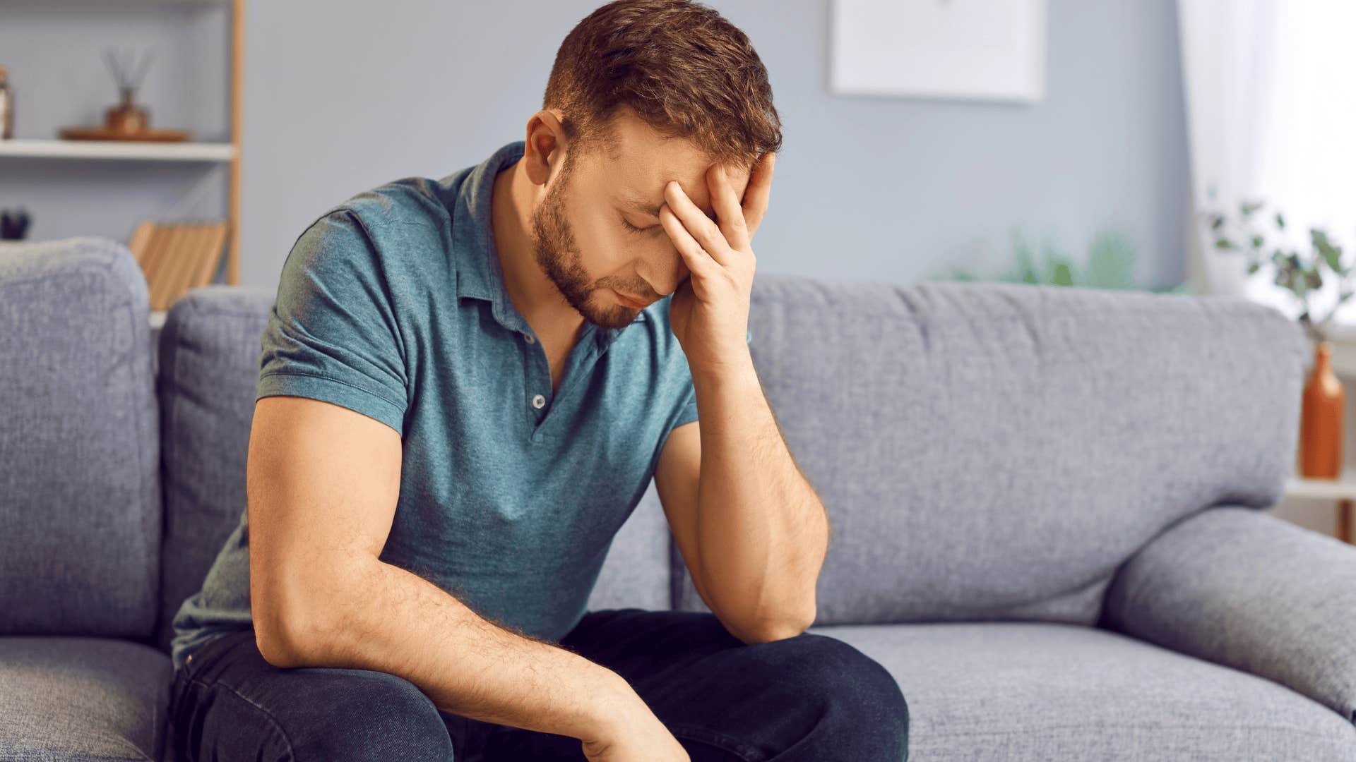 upset stressed man holding his head