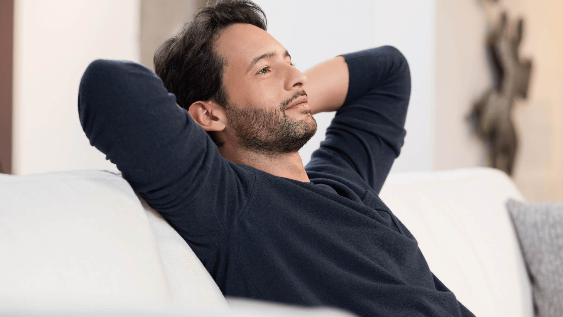 man smiling and relaxing at home
