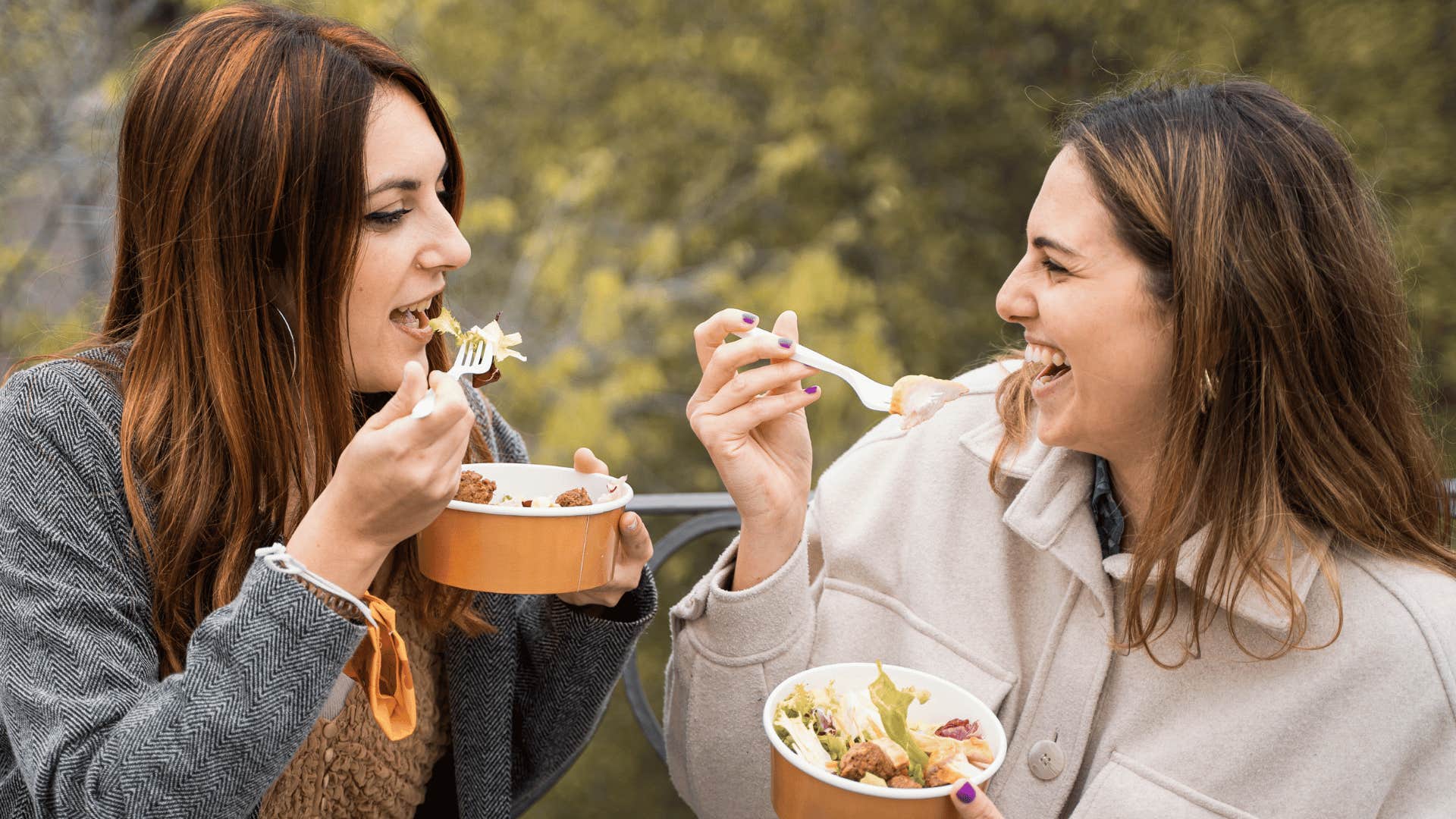 women eating with plastic dishes
