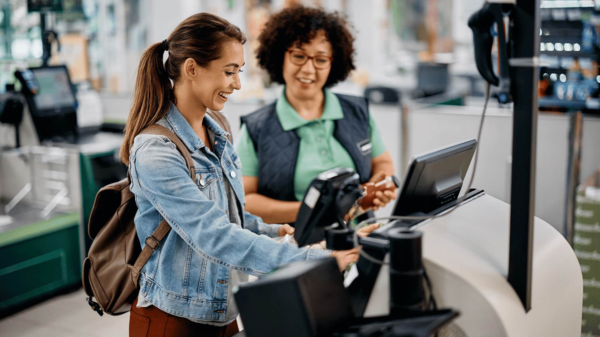 women using self check-out machines