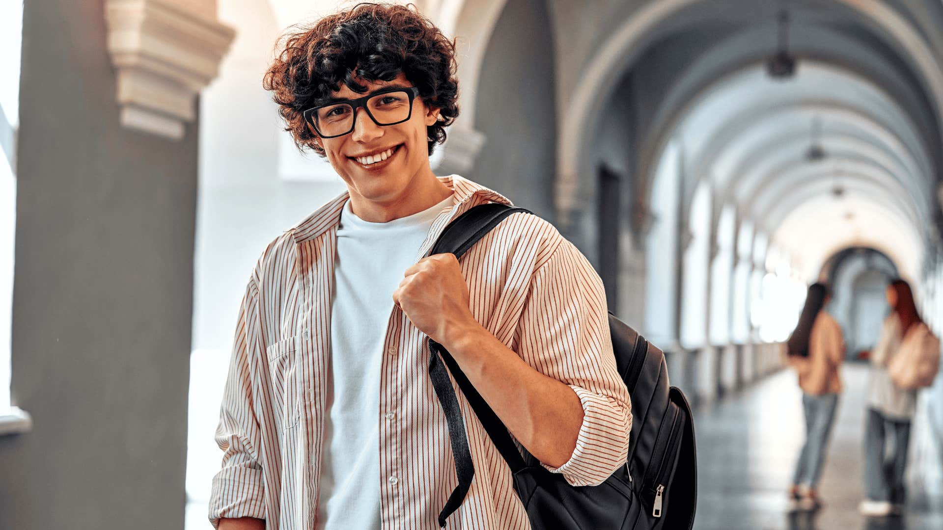 happy college student in the halls