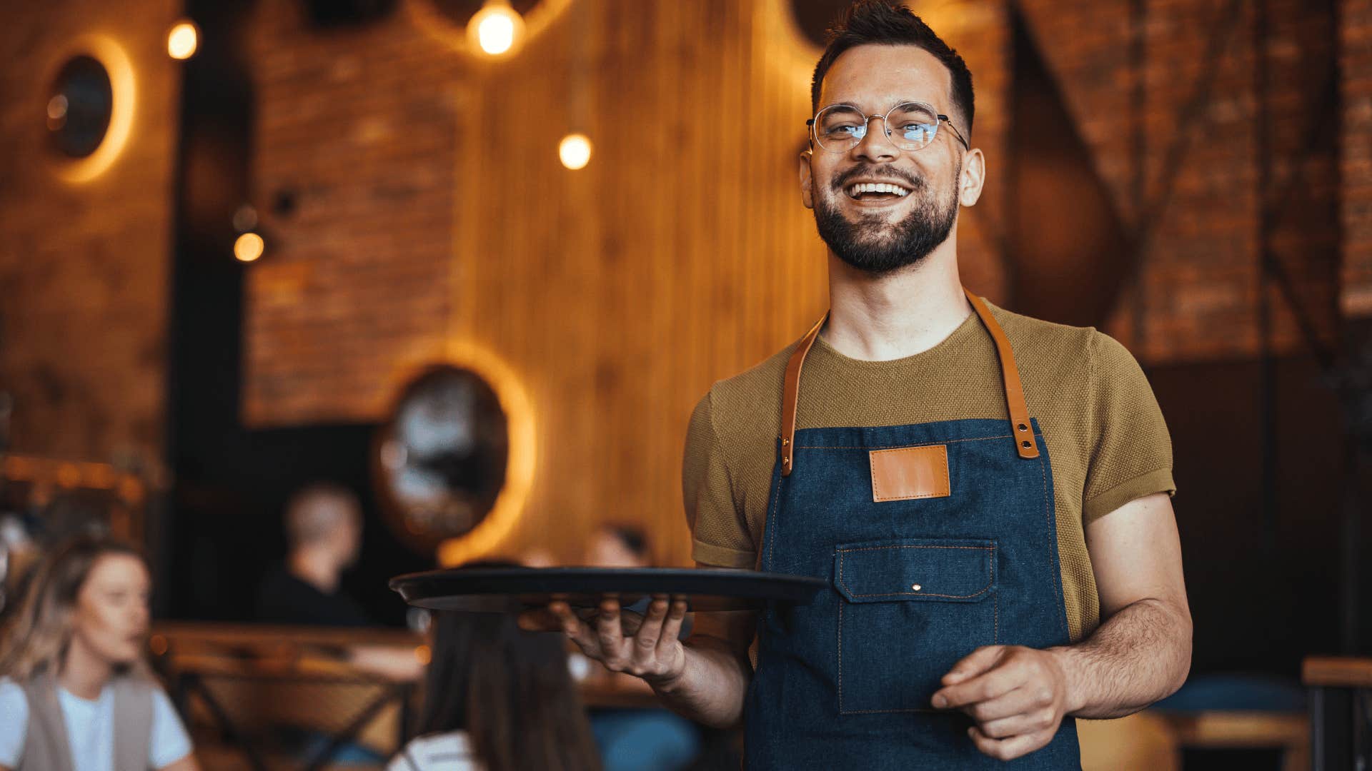 restaurant worker smiling serving food