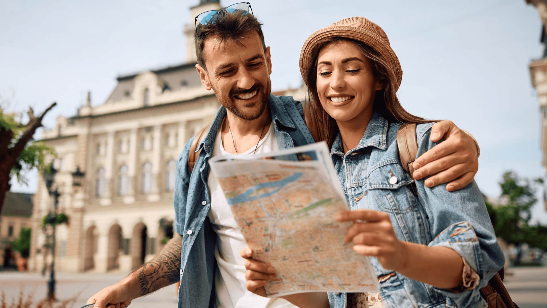 couple vacationing looking at map