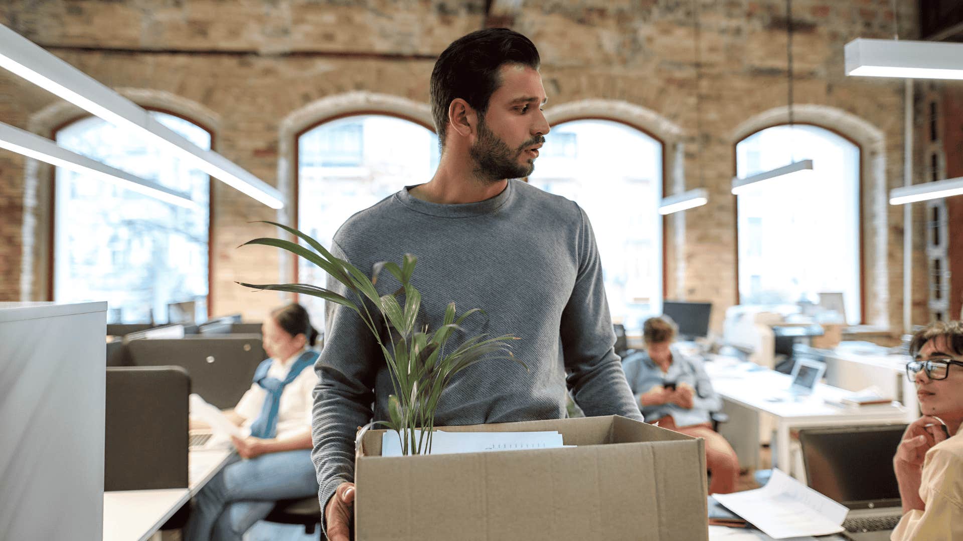 man packing his things after losing a job