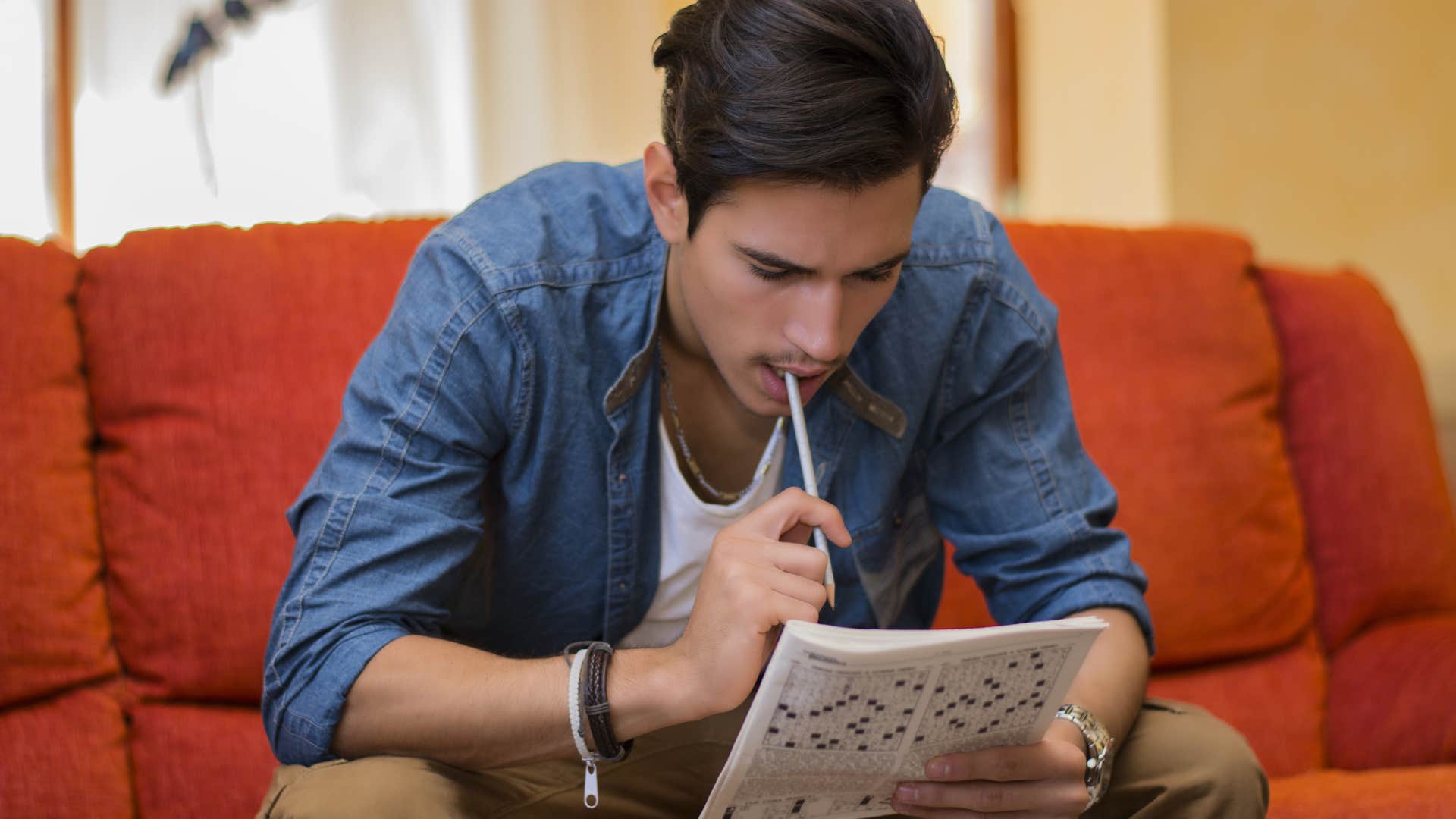 young man focusing on newspaper