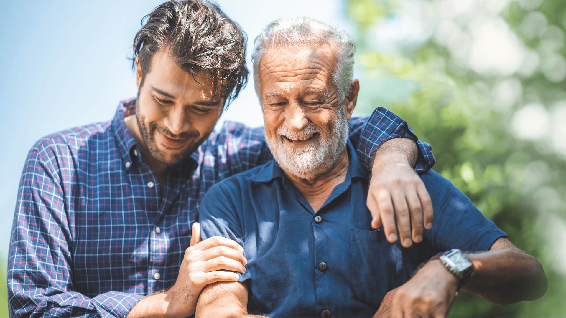 young man hugging his dad and smiling