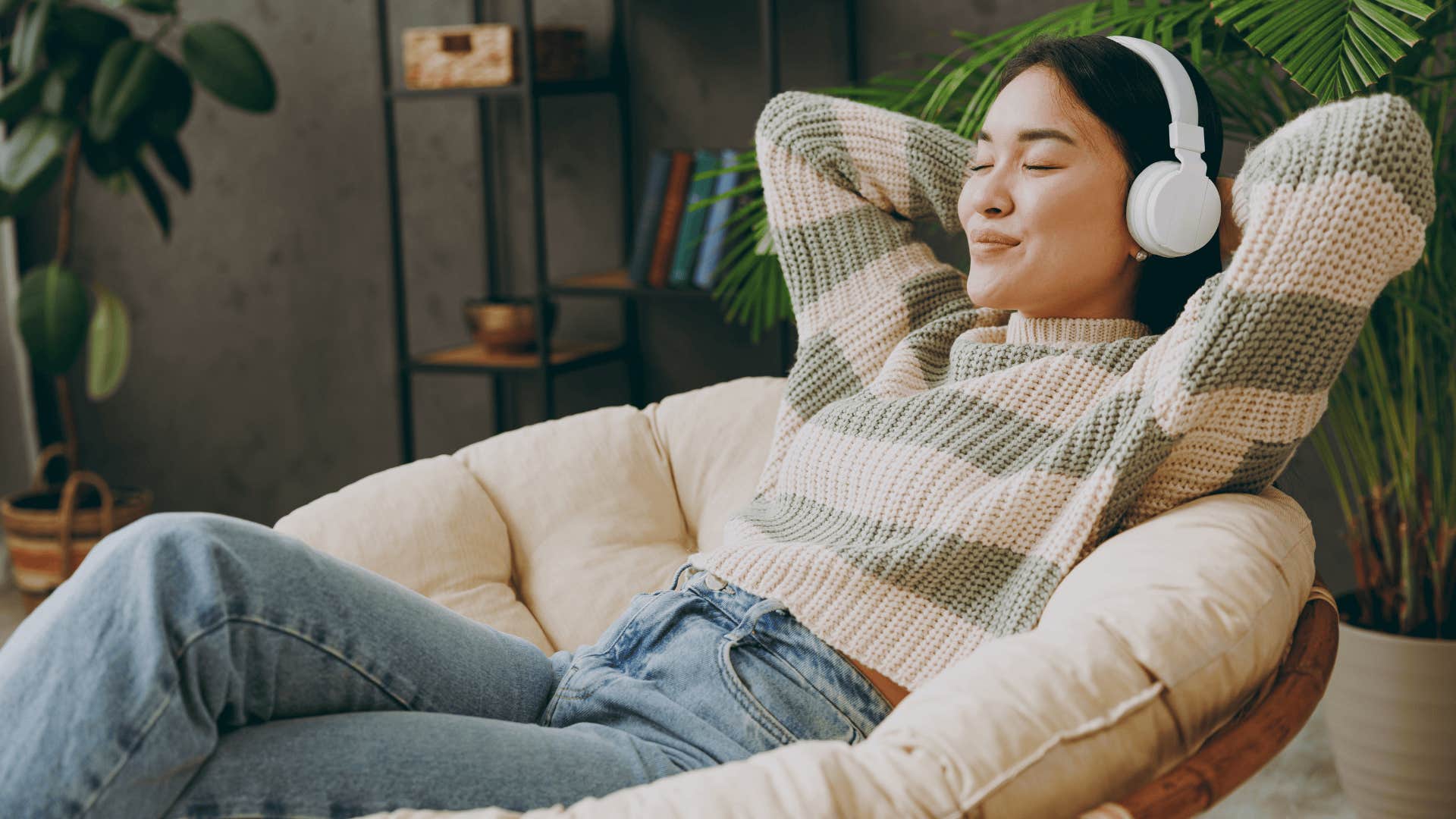 young woman smiling and relaxing listening to music