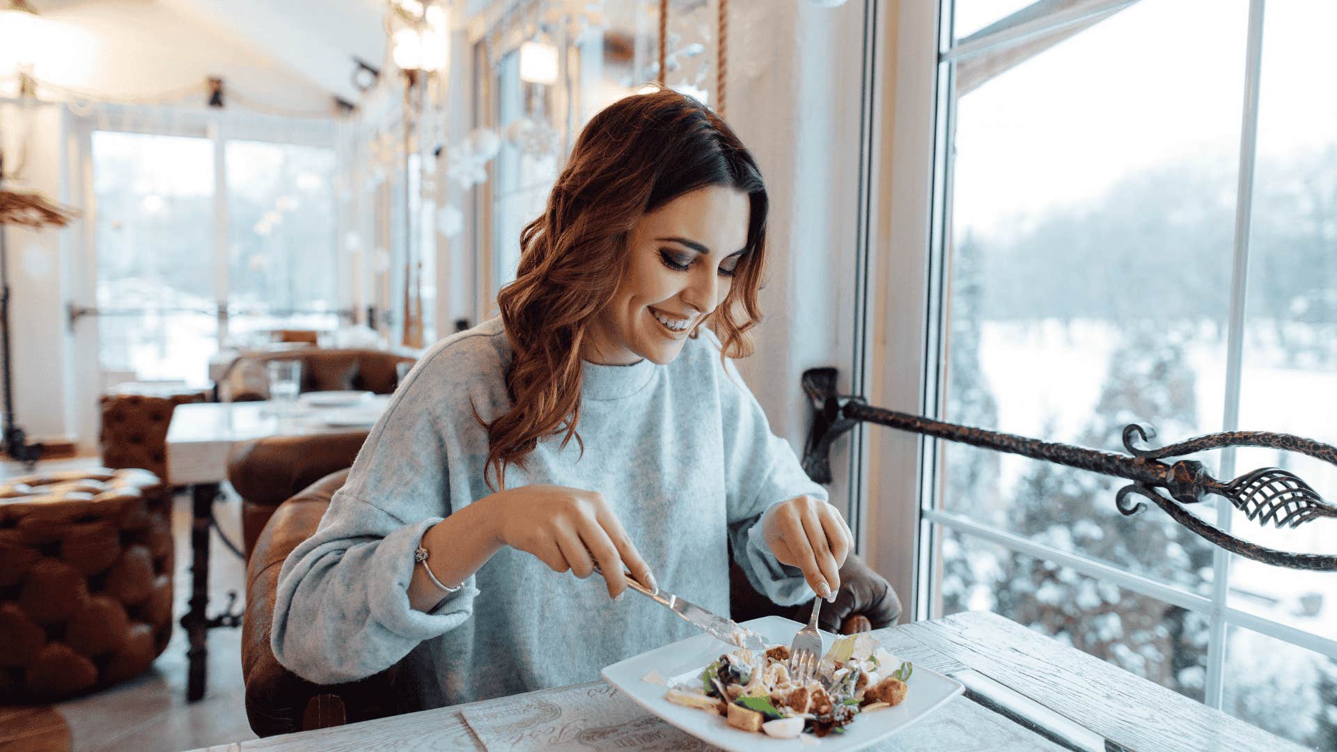 woman eating food at table