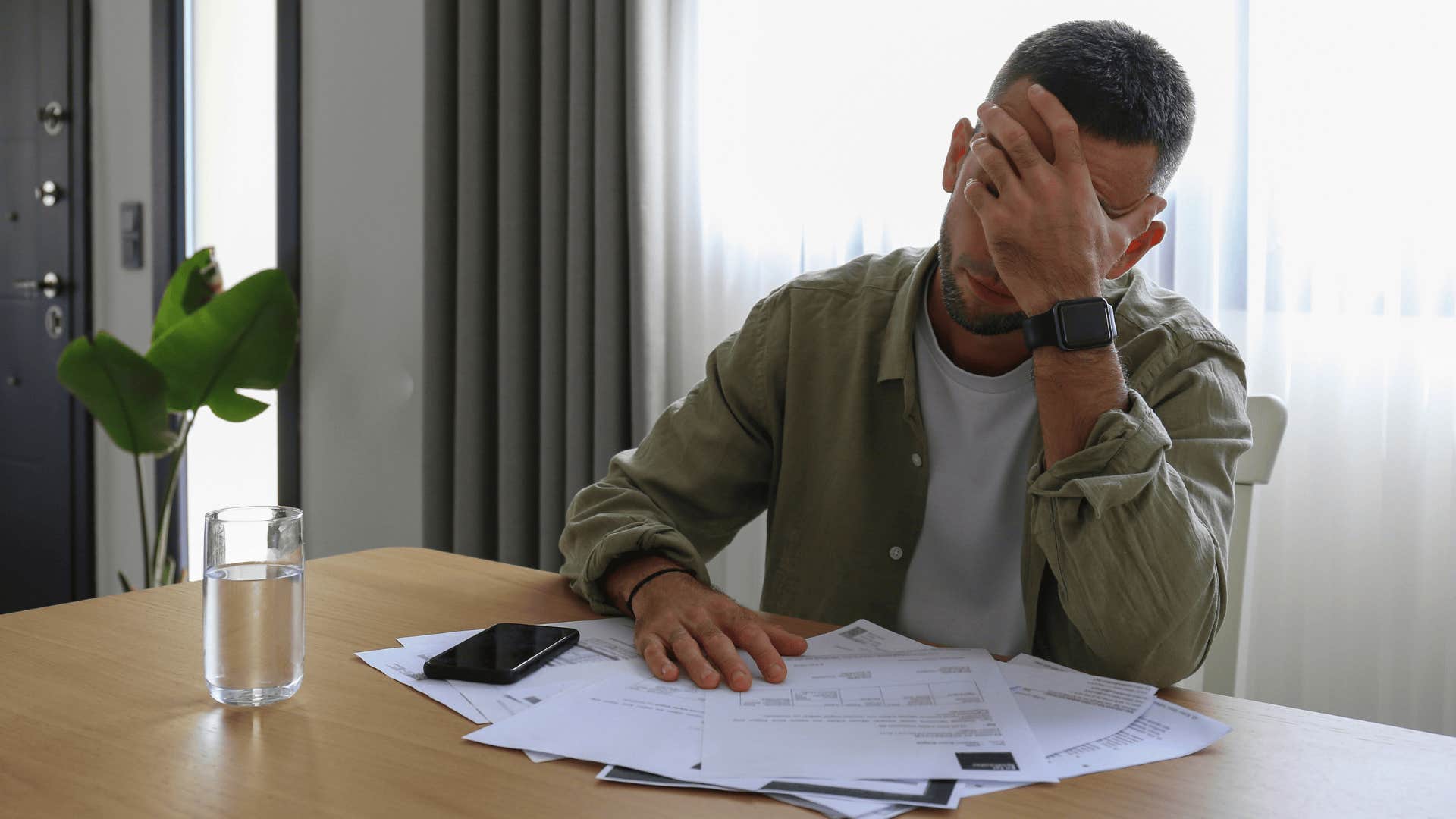 anxious man doing his bills