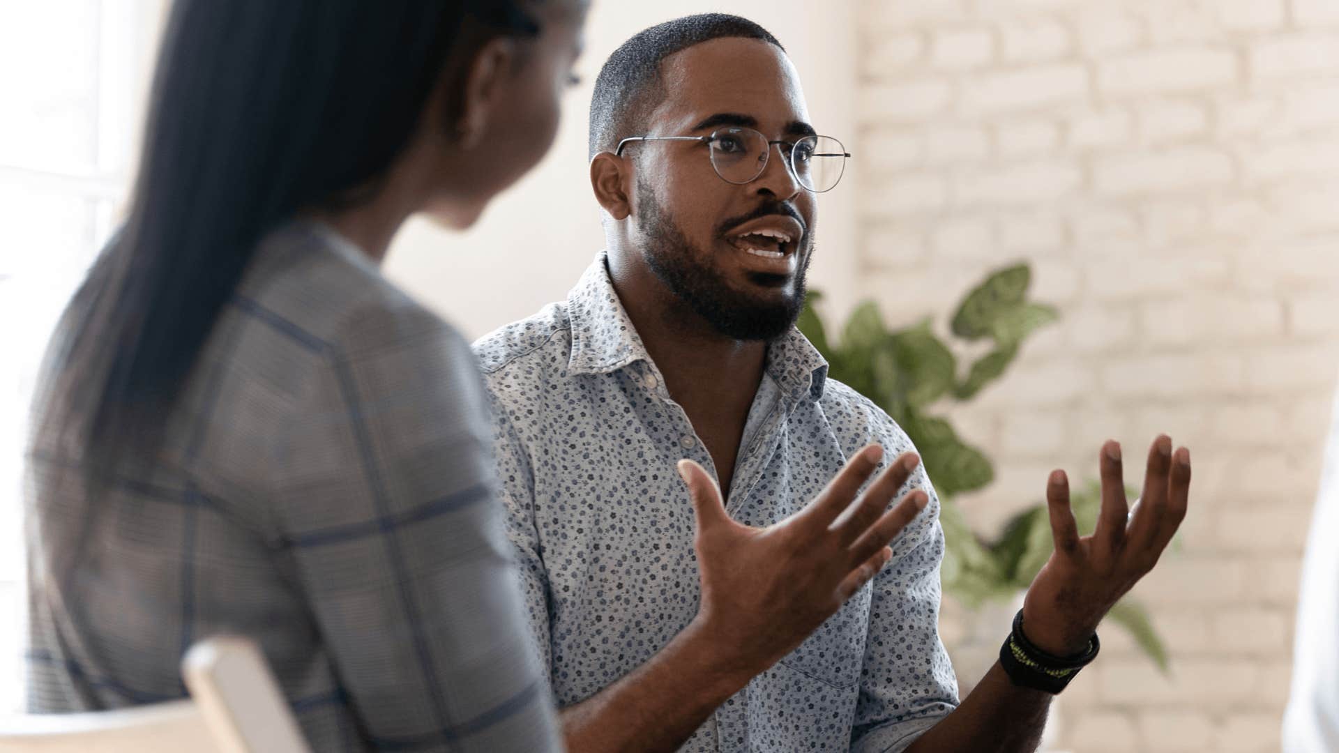 man arguing with peers at a work meeting