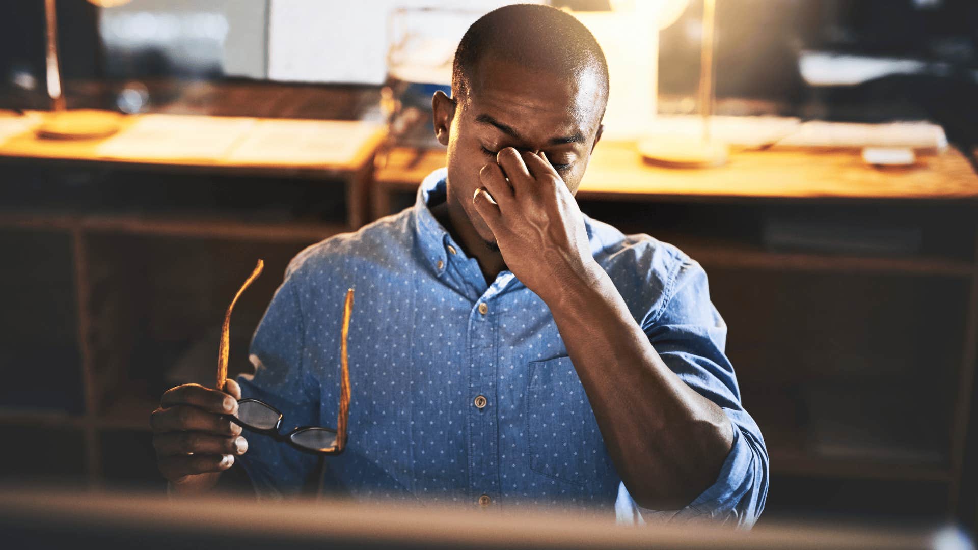 stressed man holding his head
