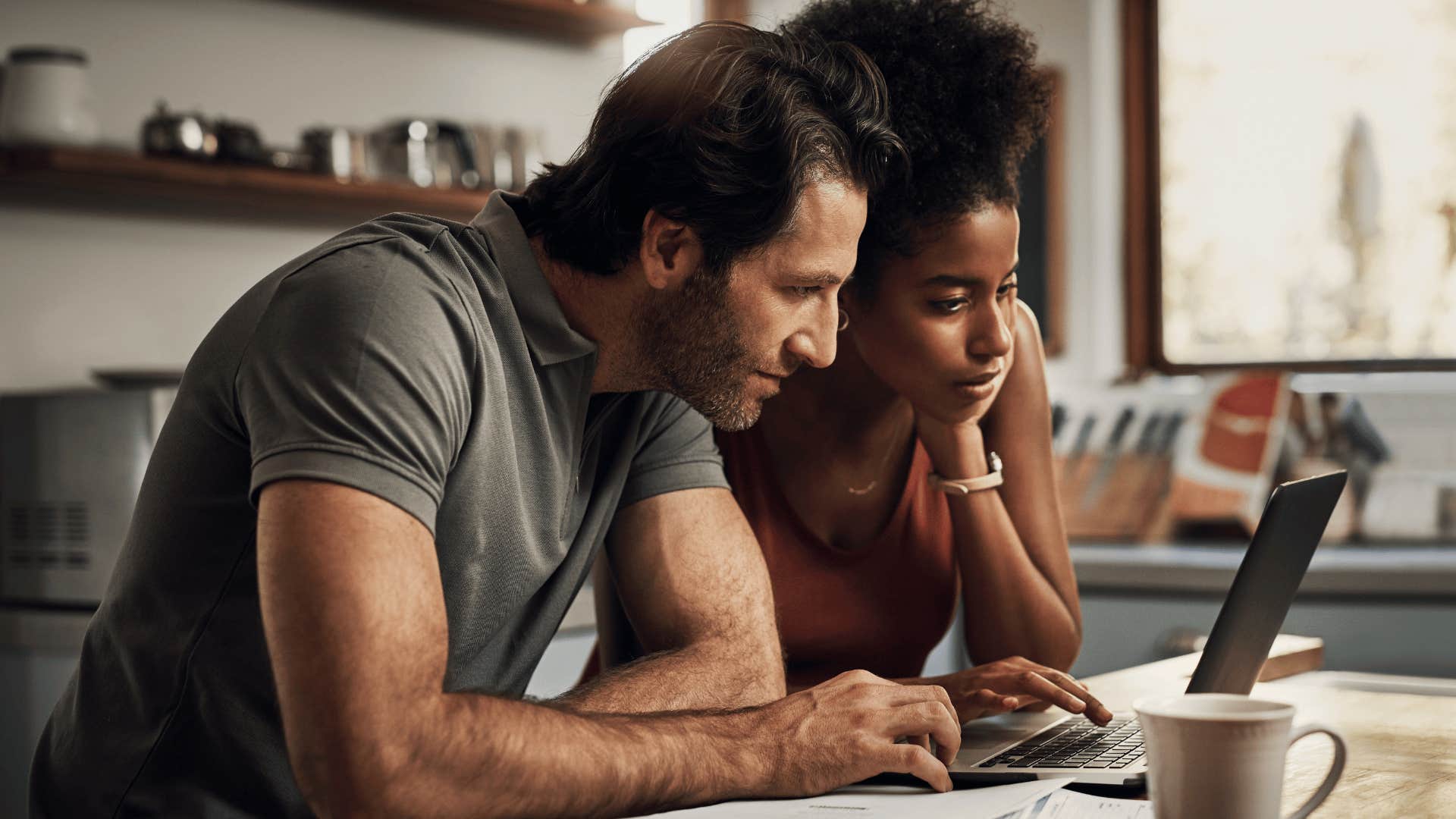 couple doing bills at their kitchen table