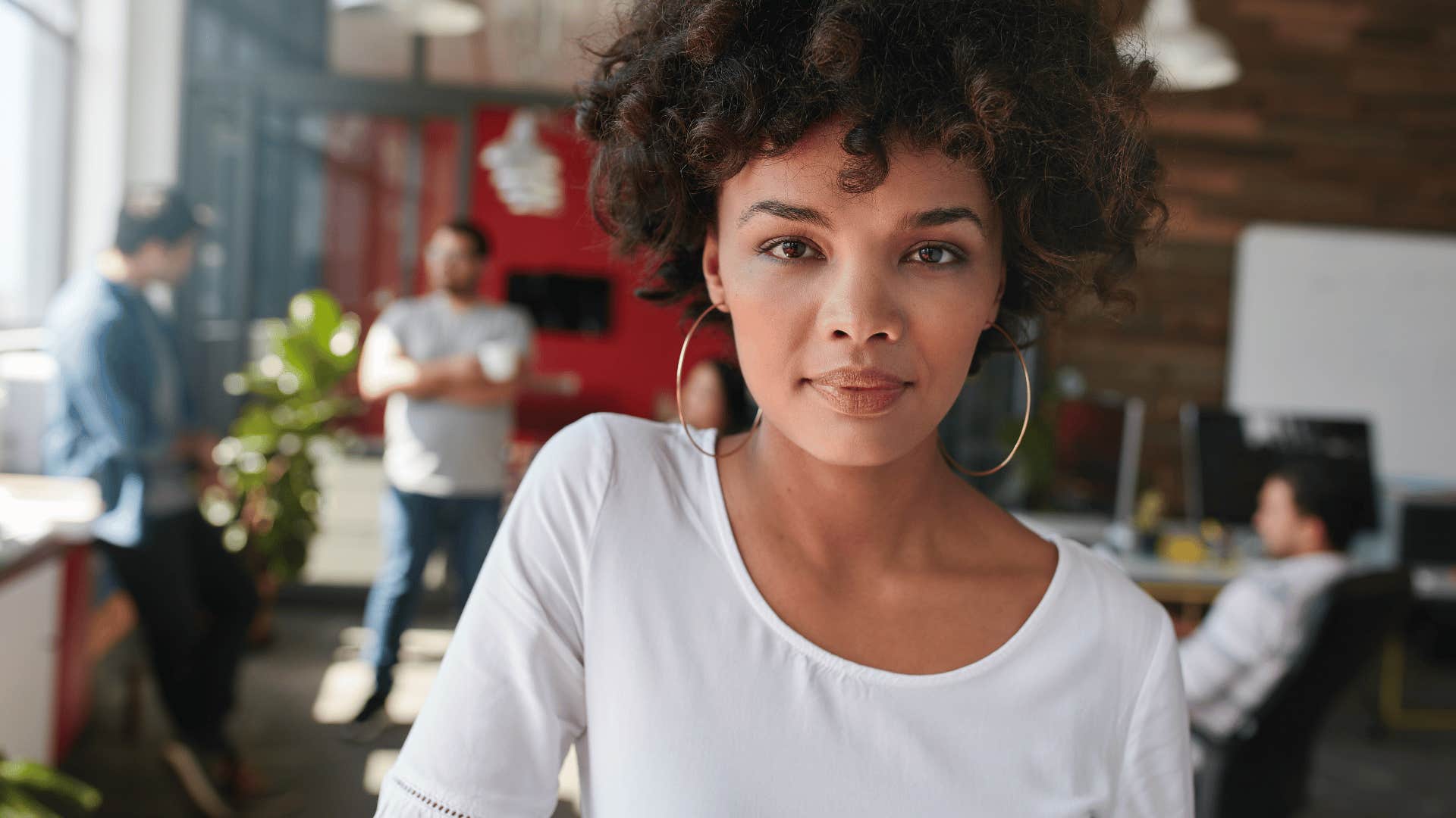 serious woman standing in public place being told to smile more