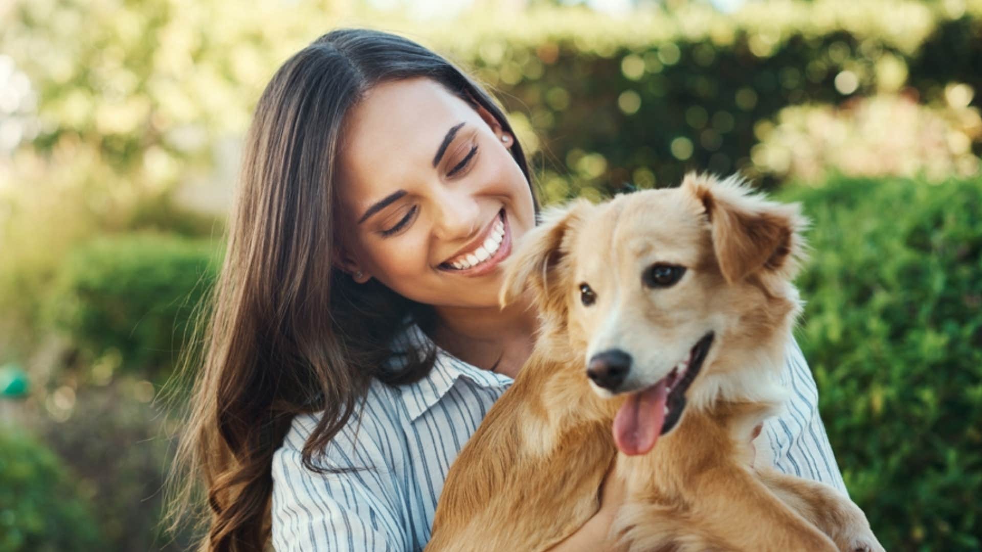 happy woman hugging cute dog