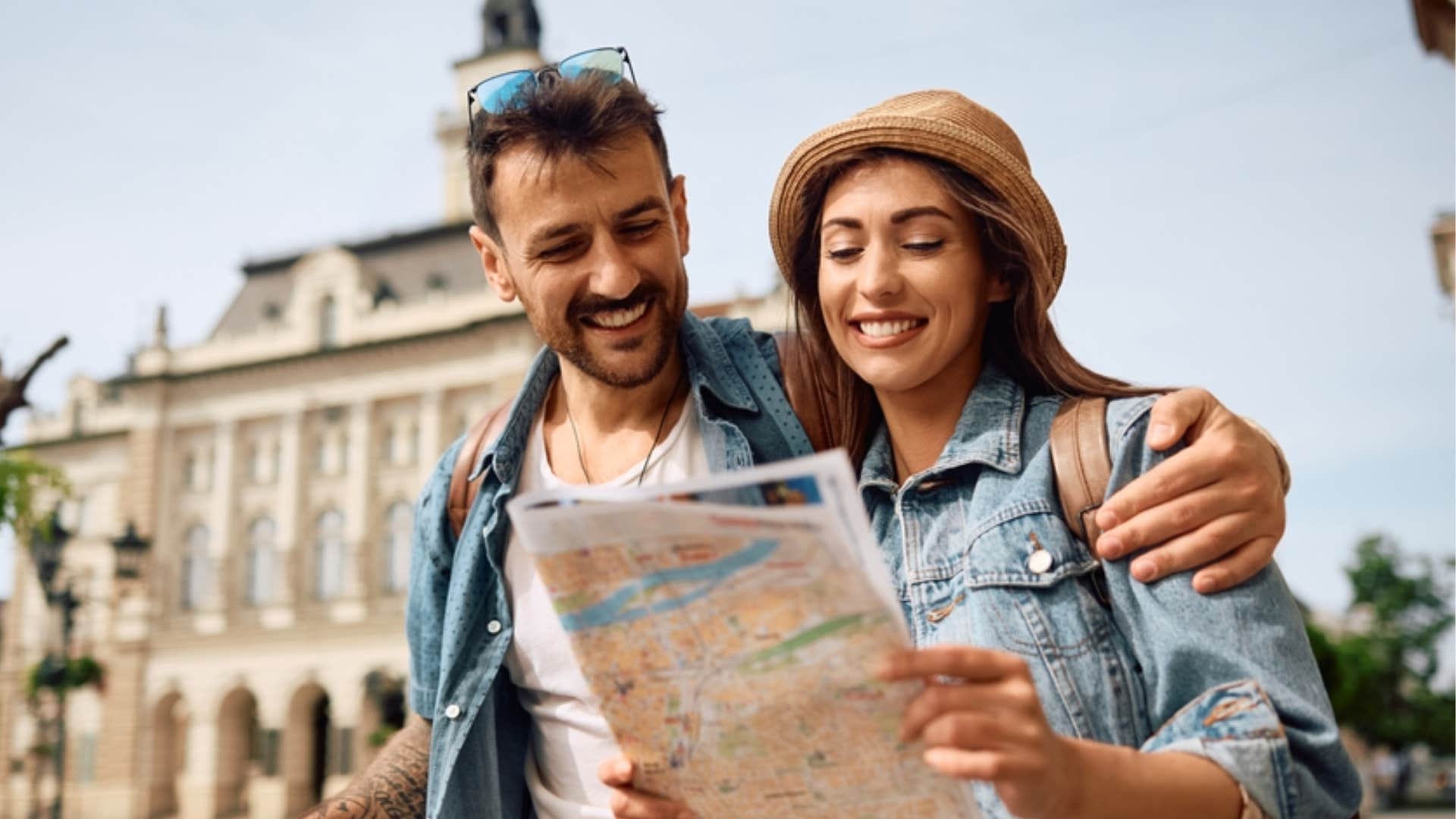 couple traveling looking at map