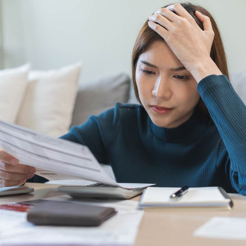 upset woman with bills because she doesn't make magic salary