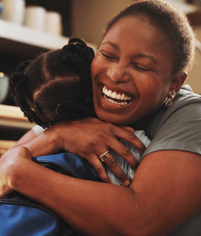 Joyful mother parenting with hugs for compassionate child
