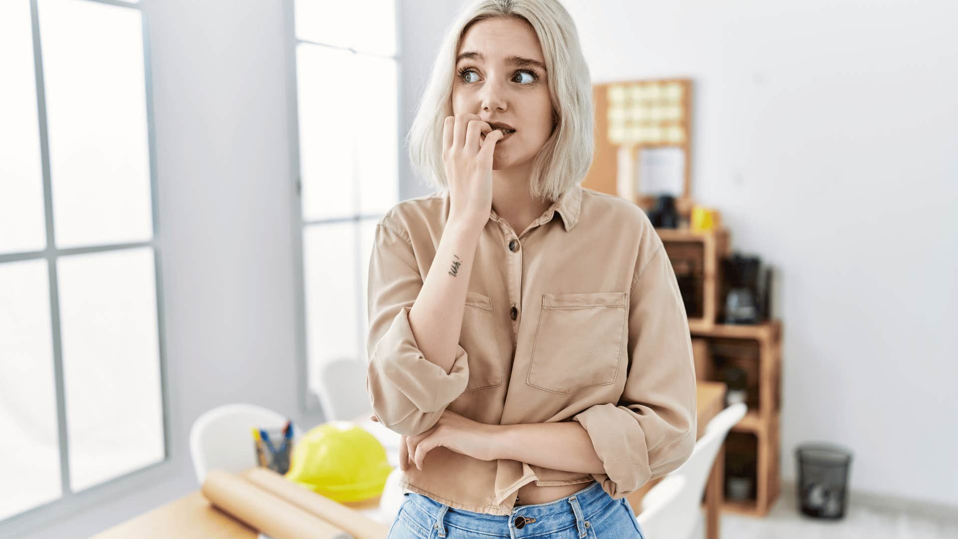 woman biting her nails anxiously