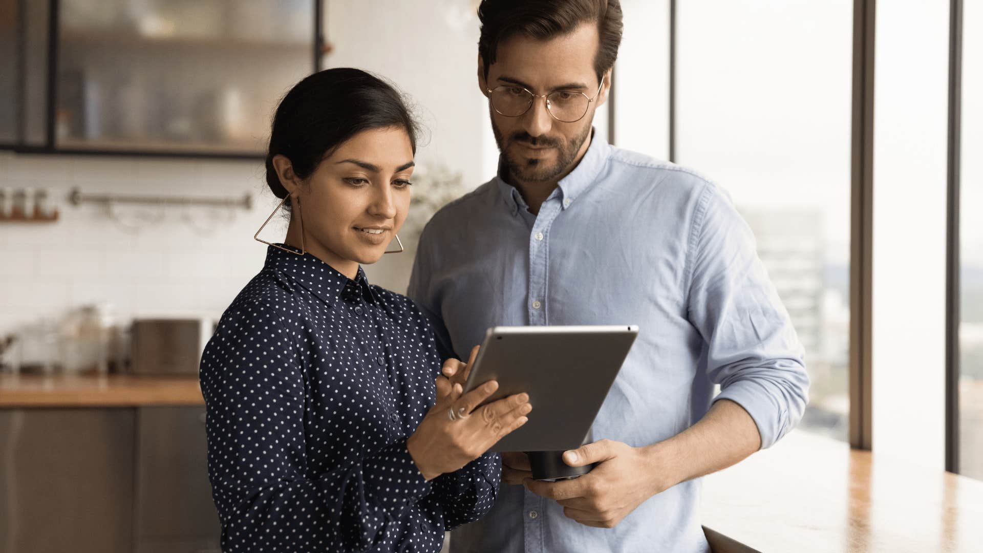 man standing too close to woman in office