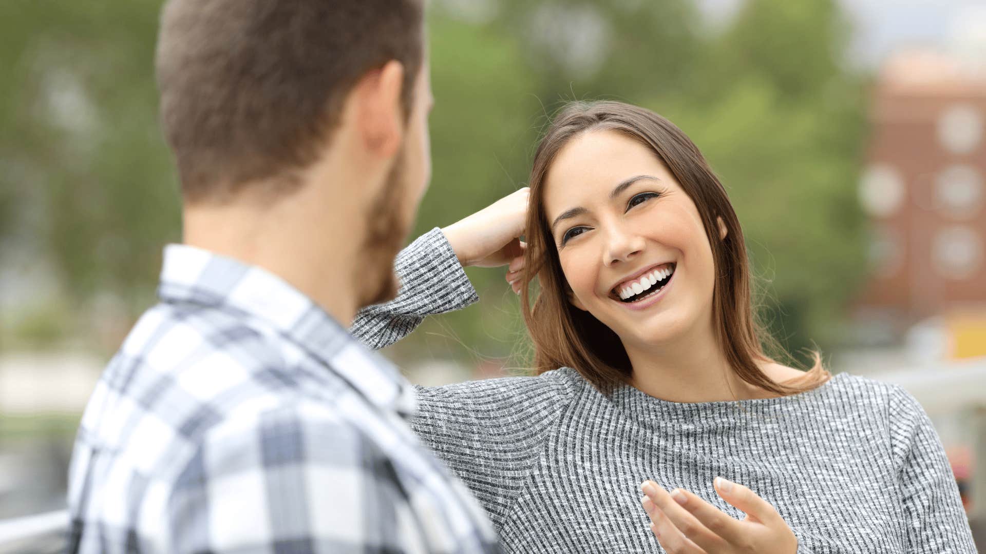 woman smiling at man with traits that make him stand out