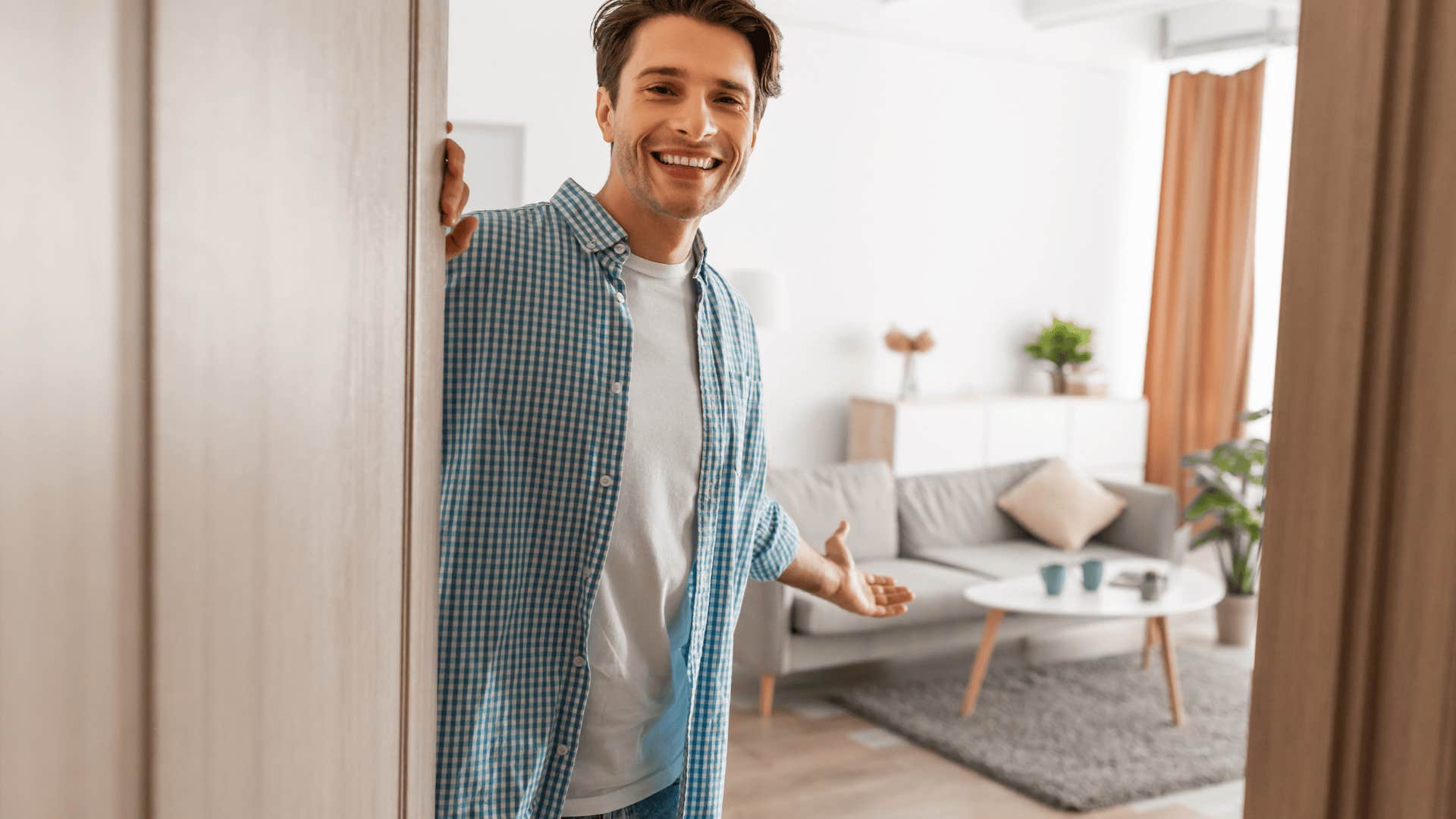man smiling opening door with traits that make him stand out