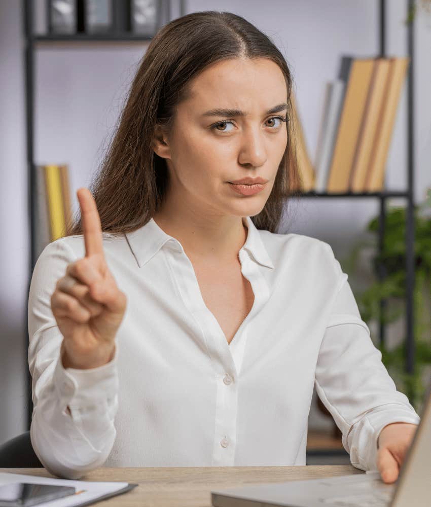 Untrustworthy woman gestures disagreement to make job a nightmare
