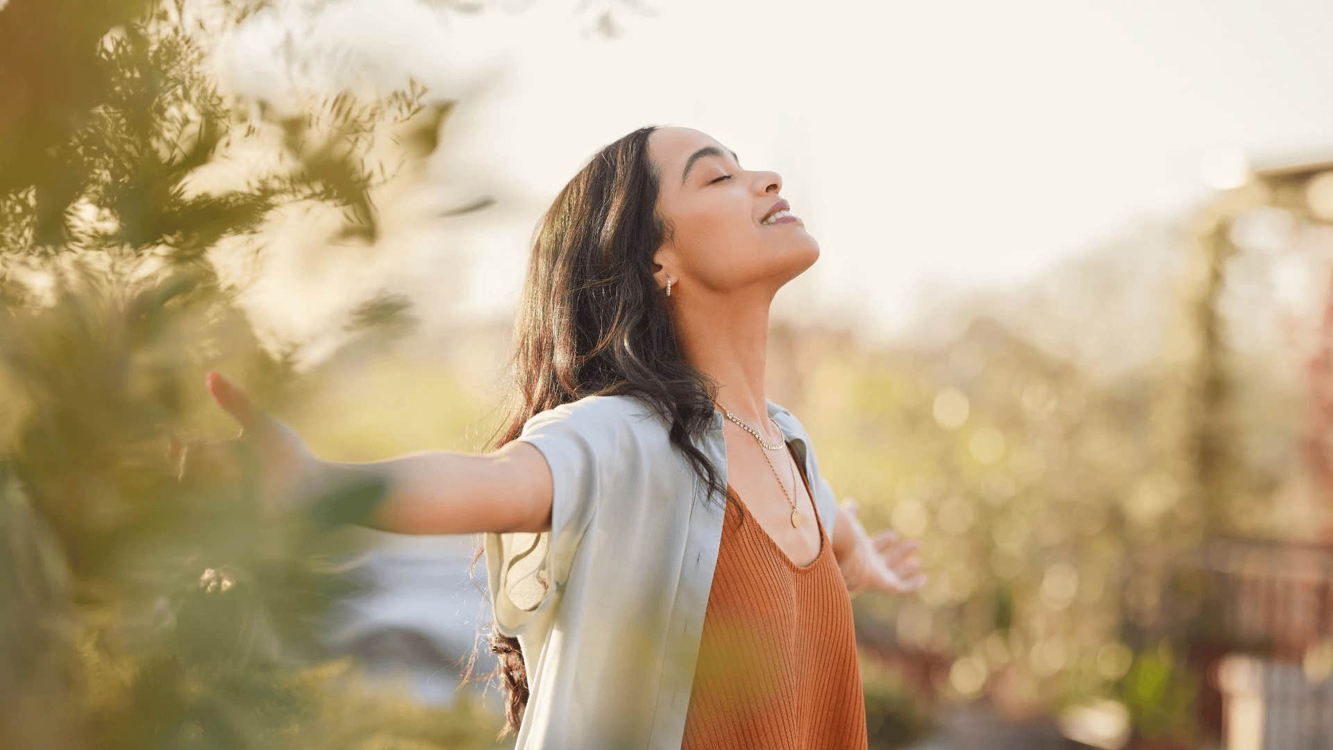 woman smiling outside because she wants to become her most authentic self
