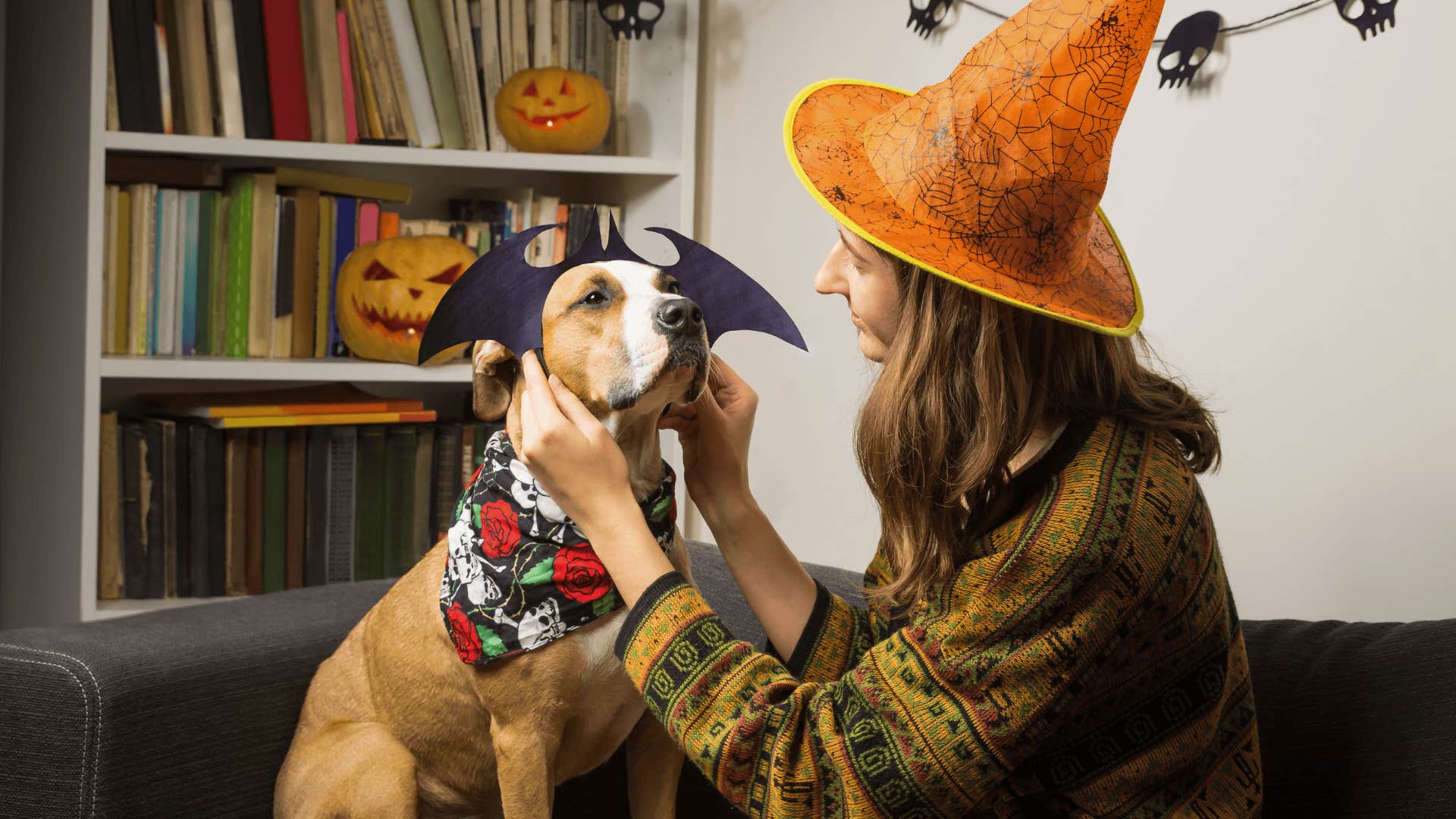 Gen Z woman dressing up her dog for Halloween