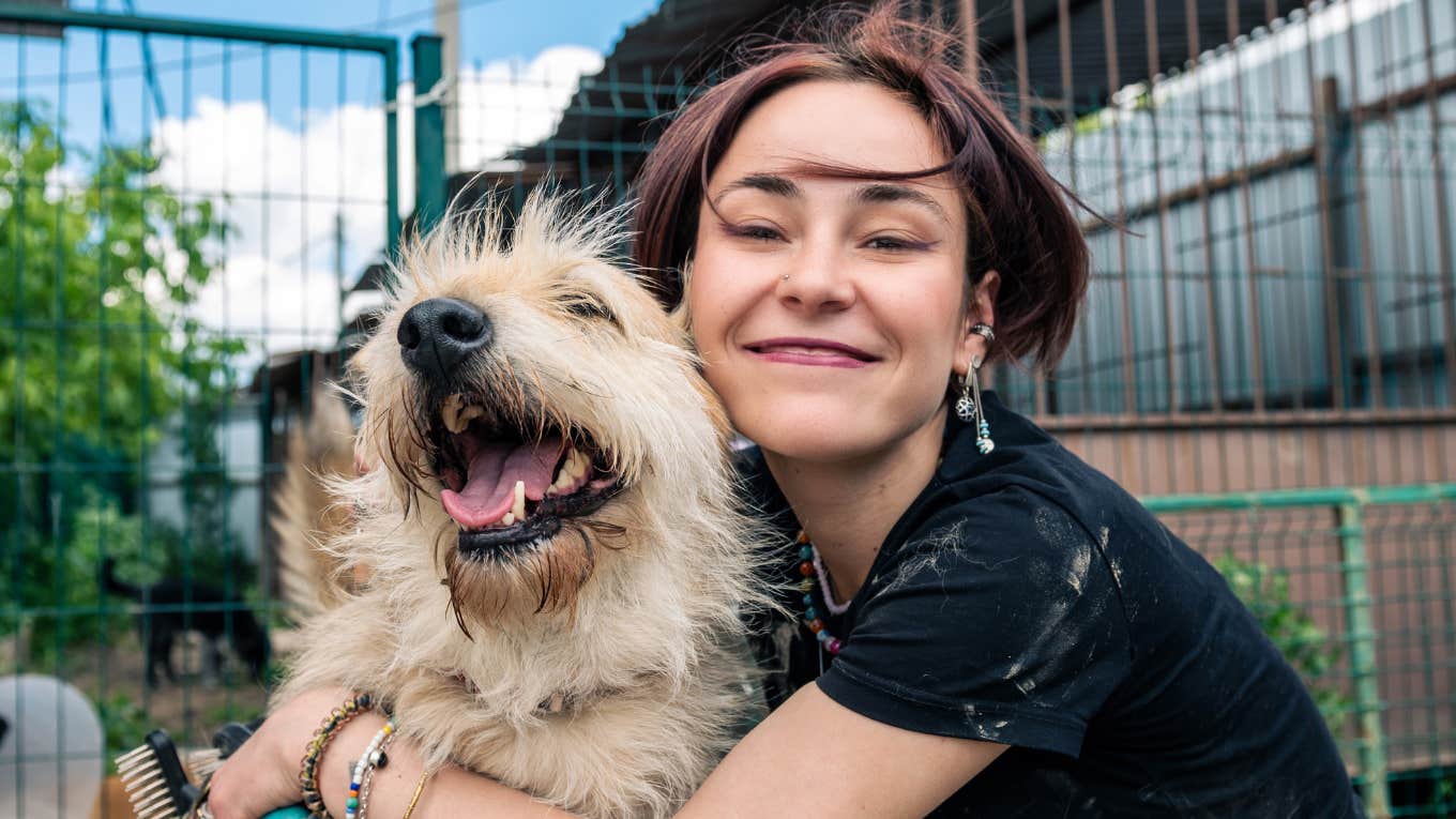 ways gen z treats their pets that boomers laugh at gen z girl hugs her dog and treats her pet in a way boomers laugh at