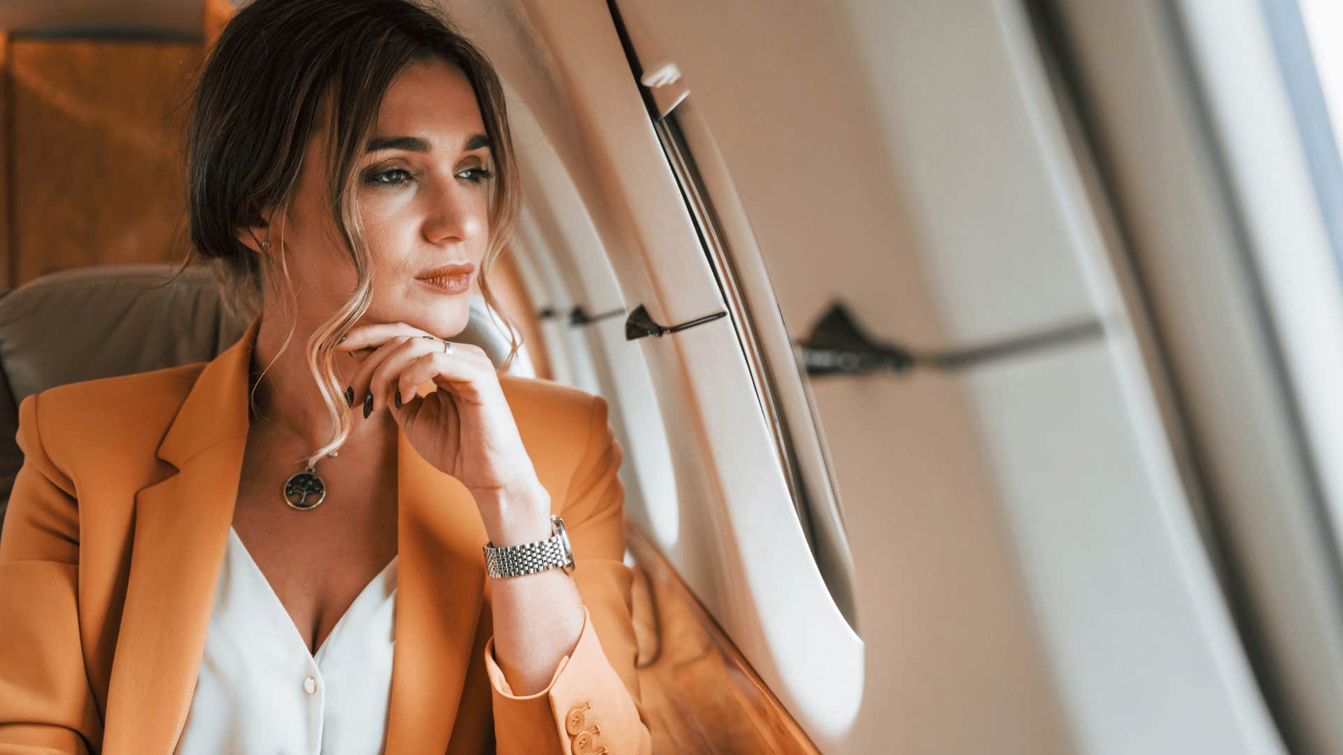woman sitting on plane because she has easy access to transportation