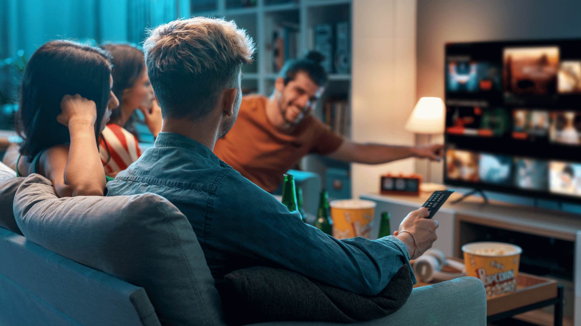group of friends sitting around tv watching streaming service